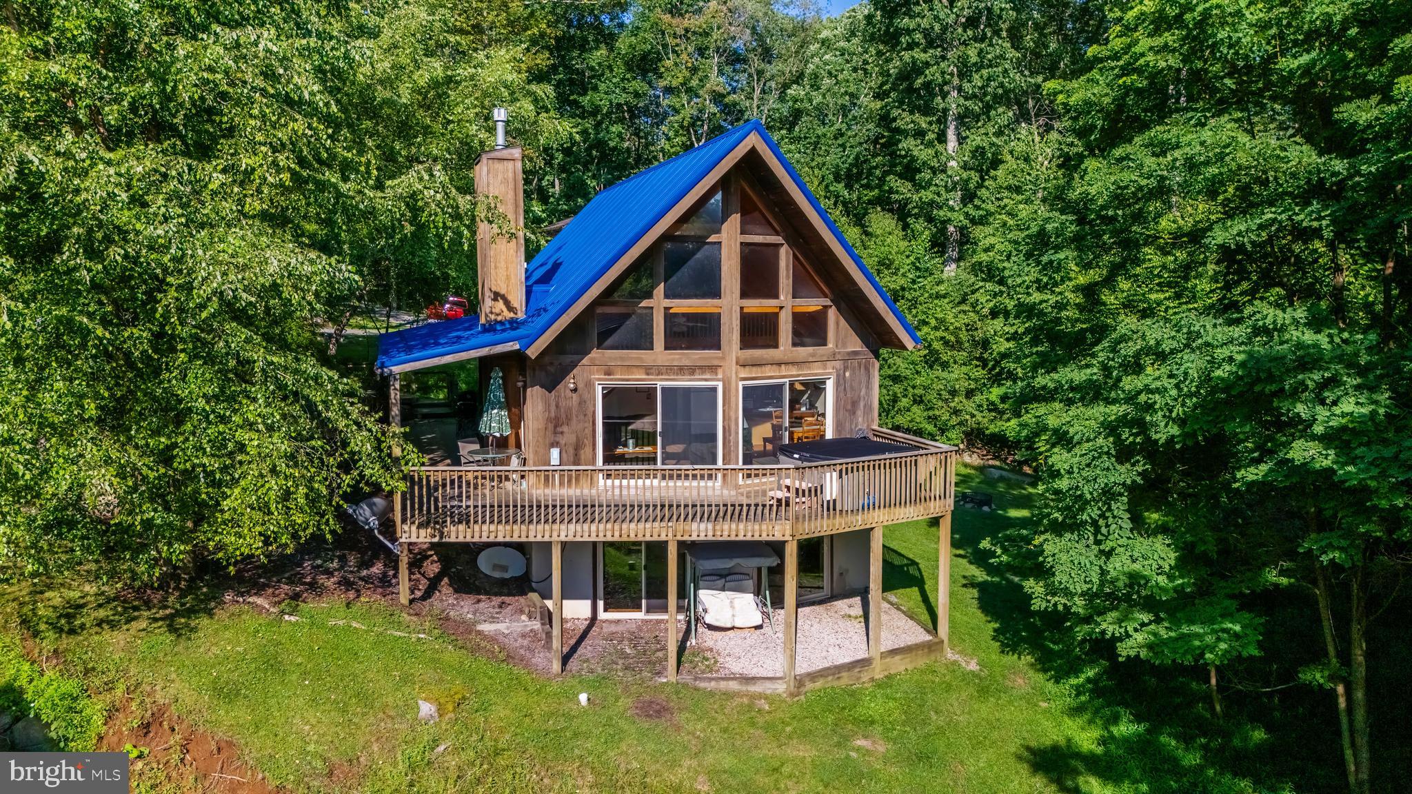 Brand new roof July 2026!3/4BR 3BA chalet with LAKE VIEWS! 2300sf vacation home fronting on a mountain stream, overlooking Deep Creek Lake! Enjoy an eat-in kitchen, exposed beams and a loft area that the current owners use as a 4th BR with bathroom. NO HOA! Conveys fully furnished. Features include central AC, exposed beams, updated flooring, gas fireplace on main level, lower level rec room with pool table and wrap-around deck with hot tub. Central location near 219 bridge, close to Wisp & local restaurants, entertainment and shopping.