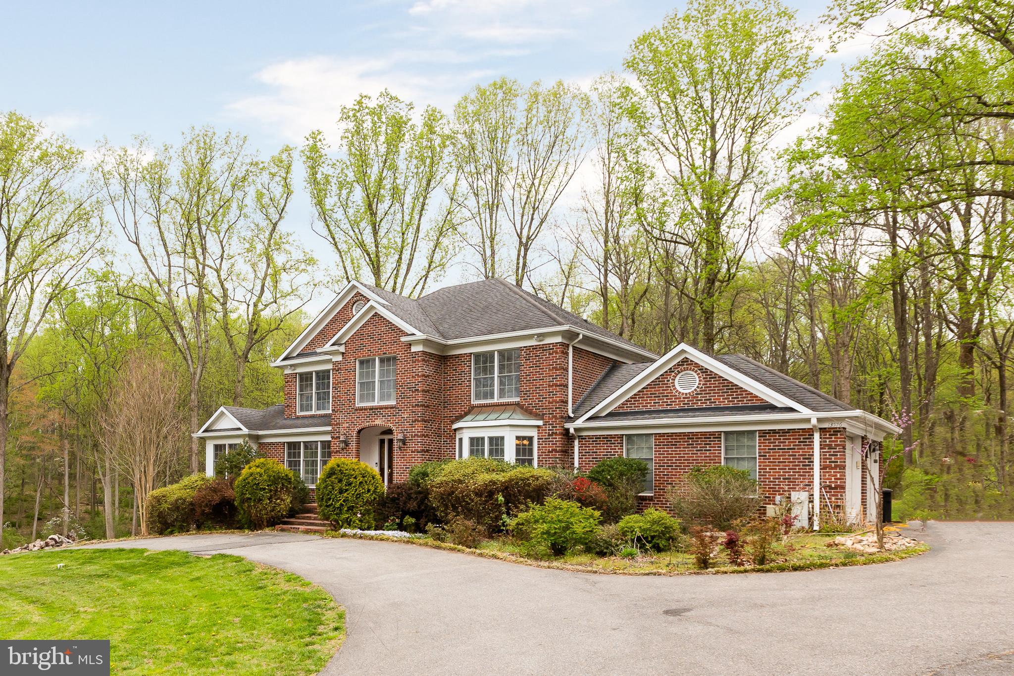 Beautifully crafted traditional residence set on 2 private, River Hill High School district, sprawling acres along sought-after Highland Road, offering an exceptional blend of elegance, comfort, and tranquility. Surrounded by picturesque wooded views, this remarkable home provides a peaceful retreat while remaining close to everything.
Inside, thoughtful contemporary design blends seamlessly with warm wood accents, architectural details, and abundant natural light, creating an inviting and airy atmosphere throughout. A circular driveway with ample parking leads to a welcoming front entrance and grand foyer. Hardwood floors span the main level, beginning with an elegant formal dining room highlighted by exposed beams.
The main living spaces are both stylish and functional, featuring a cozy living room, a sun-filled library or home office, and a spacious family room with a wood stove insert fireplace, custom built-ins, and sliding glass doors that open to a large screened deck—perfect for entertaining or relaxing with scenic views.
At the heart of the home, the gourmet eat-in kitchen impresses with a bright breakfast area and bay window overlooking the woods. Designed for both everyday living and entertaining, it features a central island, custom range hood, ceiling-height tile backsplash, ample cabinetry, and high-end finishes.
Upstairs, you’ll find four generously sized bedrooms and two full bathrooms, including a luxurious primary suite with vaulted ceilings, a large walk-in closet, and a spa-inspired bath complete with dual vanities, a soaking tub framed by windows, and a separate shower.
The walkout lower level expands the living space with a recreation room, open bonus area, and extensive a den or office or guest bedroom.
Outdoor living is truly exceptional, with a patio, pergola-covered deck, and screened porch overlooking the beautifully landscaped yard and serene wooded setting—perfect for peaceful relaxation or effortless entertaining.
Ideally located, this home offers convenient access to Clarksville’s vibrant town center with shopping, dining, and recreation. Downtown Columbia and Historic Ellicott City are just minutes away. Easy access to Routes 32, I-70, and Route 29 makes commuting to Baltimore, Washington, and the BWI business corridor a breeze. Nearby major employers include Howard County Medical Center, JHUAPL, and Fort Meade/NSA.
A rare opportunity to own a distinctive home that perfectly balances privacy, design, and convenience.