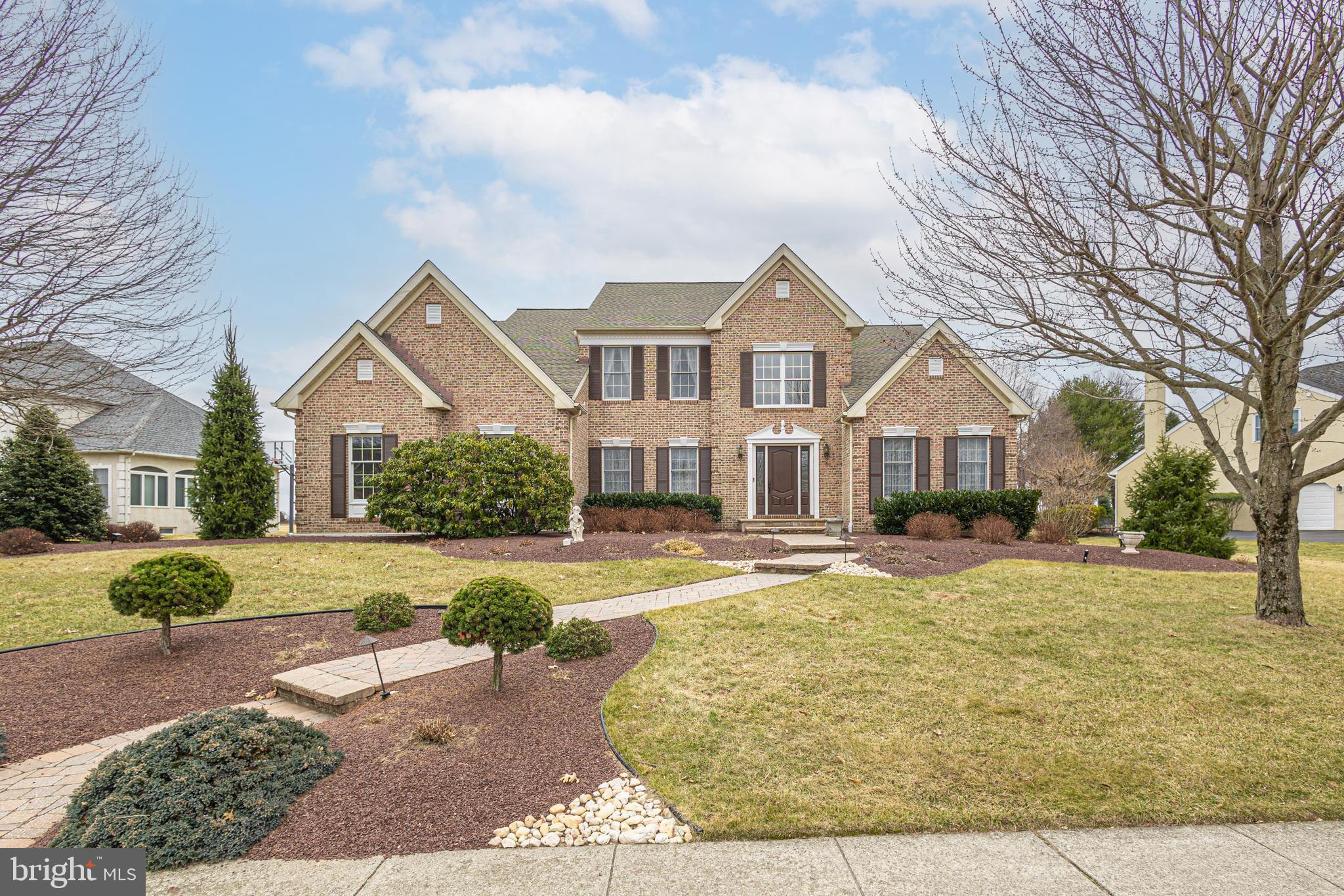 Proudly showcasing this beautifully and well-maintained 4 bed, 2.5 bath home in desirable Lower Makefield Township offering unparalleled curb appeal with its lush lawn and meticulously manicured landscaping. This exquisite home boasts an impressive presence with its striking brick façade and tiered paver walkway, nestled on just under a half-acre expansive premium lot within the admired Bridle Estates community. Walk through the front door to be greeted by gleaming hardwood floors that flow seamlessly throughout the main level as you immediately fall in love with the bright, open layout and the upgraded wrought iron turned staircase. As you tour the main level of the home you will notice the owners spared no expense upgrading the moldings and trim work throughout. The inviting 2-story gathering room, open to the kitchen area, makes a grand appearance and exudes a sense of airiness and charm with its stunning floor-to-ceiling brick fireplace, second floor overlook and full wall of windows allowing for streams of natural light and a sun-drench opulence. The updated kitchen, accompanied by a convenient eat-in area for casual dining, features awing quartz countertops, wrap around island, real wood cabinets and a nearby custom-built butler station equipped to tie it all together. Retreat and unwind down the hall in the convenient main floor primary suite adorned with vaulted ceilings, sitting area and his/her walk-in closets. The en-suite bath, highlights a double sink vanity, soothing soaking tub, and a glass-enclosed tiled shower providing a serene sanctuary. A desired half bath completes this level. Head up the stairs off the foyer to find a surprise bonus room currently utilized as an office and 3 bedrooms, each sharing a full hall bath. Downstairs you will find a finished lower level providing additional living space with multiple entertainment areas including a media room, game room, exercise area and great storage. The entire home offers the essence of stylish comfort and features numerous upgrades, including the expansive backyard patio offering open farmland views providing privacy, custom front door, custom built-ins, wood flooring, newer roof, remote shades in the primary suite, UV protective film on windows, irrigation system, freshly painted 2-car garage with new epoxy floor, shed and finished lower level. Located within the award-winning Pennsbury School District on a premium lot with convenient access to shopping, dining, major highway commuting routes, Septa and NJ Transit lines, airports, and major hospitals. Don't miss the opportunity to make it yours today!