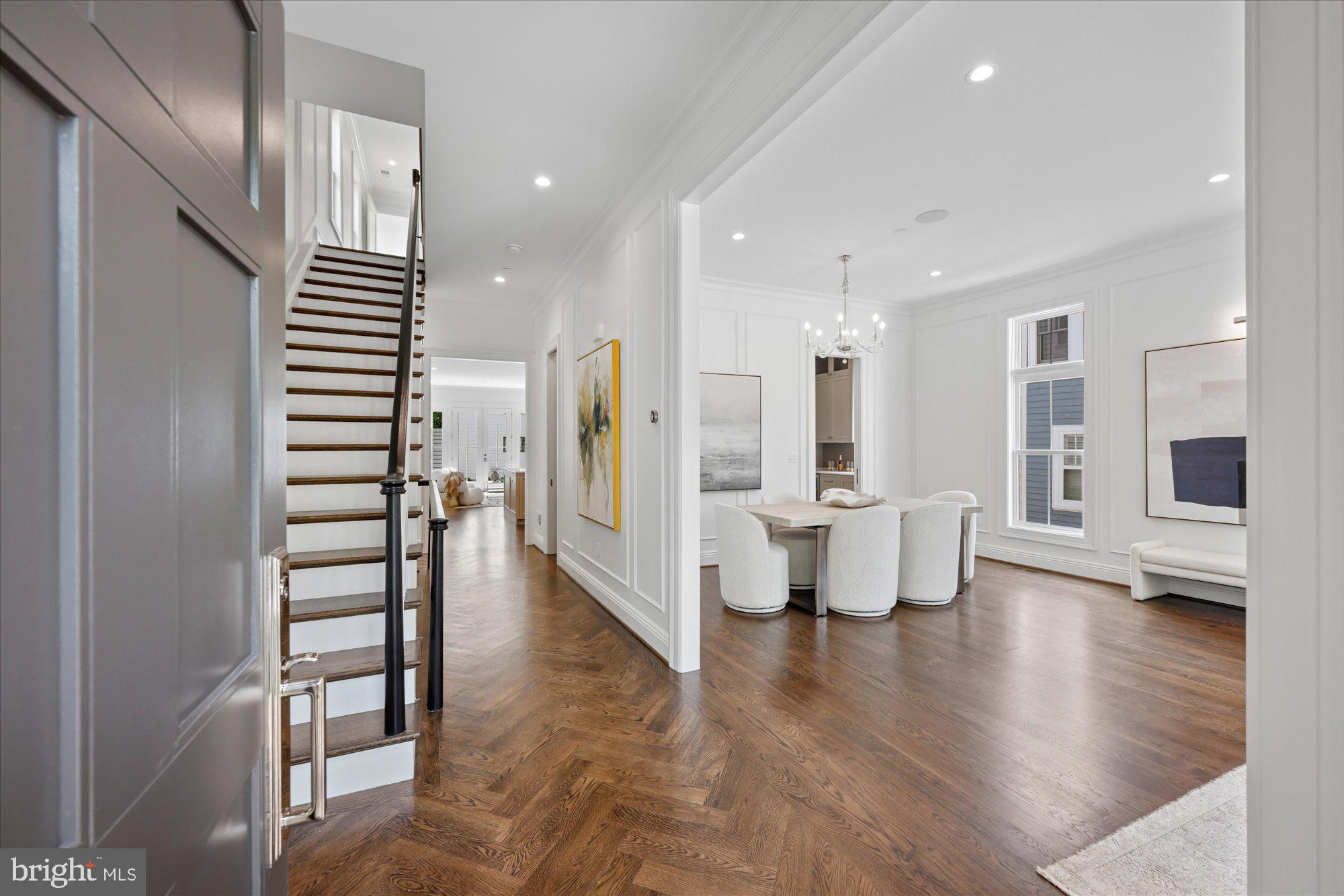 Welcome to 4631 49th Street NW, the latest exceptional offering by Summit Homes in coveted American University Park. With over 5,300 square feet of beautifully crafted living space across four finished levels plus a detached two-car garage with a guest suite, this residence perfectly balances spacious design, beautifully curated finishes by Edith Gregson Interiors, and exceptional craftsmanship.

The main level showcases 10+ foot ceilings and an effortless flow designed for both entertaining and everyday living. A formal dining room transitions into an expansive living room. The chef’s kitchen, appointed with Wolf and Sub-Zero appliances, a butler’s pantry, and a large center island, opens to a sunlit family room with a gas fireplace, Frame TV, and direct access to the rear deck. A powder room and mudroom complete the level.

Upstairs, nearly 10-foot ceilings continue in the serene primary suite, featuring a walk-in closet and a spa-like bath with a soaking tub and oversized shower. Three additional bedrooms, including one en-suite, a hall bath, and a dedicated laundry room complete this floor.

The top level offers a fifth bedroom, full bath, and a spacious lounge with a wet bar and Frame TV, opening to a rooftop terrace with sweeping treetop views - the perfect spot  for relaxing or entertaining.

The finished lower level features 9-foot ceilings, a large recreation room with built-in seating and storage, a sixth bedroom, an office, a full bath, and flexible space for a gym or storage. Above the detached garage outfitted with an outlet for an EV charger, a 460-square-foot guest suite with a walk-in closet and full bath provides an ideal setup for visitors, an au pair, or extended stays.

Thoughtful design details including custom cabinetry throughout, tankless water heating, pre-wiring for a security system, and hardwired CAT6 connectivity for fast, reliable internet in every room are complemented by a built-in AV system with three zones of speakers serving the main level and upper-level living areas, reinforcing the home’s consistent standard of quality, efficiency, and craftsmanship.

Ideally located just one mile from both Friendship Heights and Tenleytown Metro stations, and two blocks from a direct bus to Georgetown and Downtown DC, the home offers exceptional convenience. Wisconsin, Western, and Massachusetts Avenues are all nearby, and Spring Valley favorites like Millie’s, Compass Coffee, and Wagshal’s are under half a mile away. Beloved Turtle Park is just one mile from your doorstep!