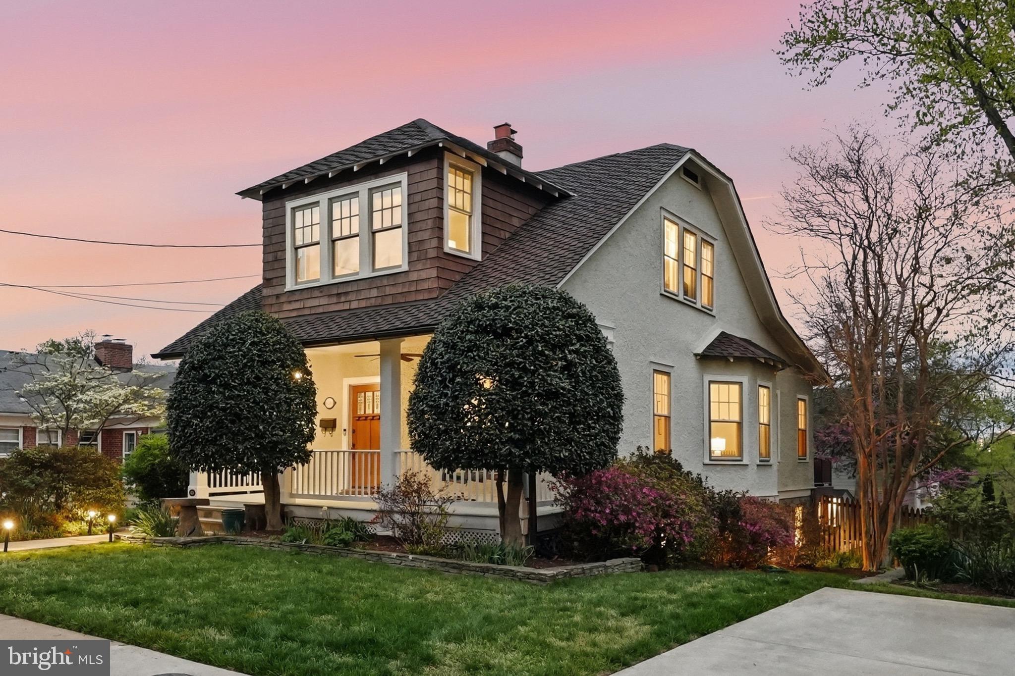 Welcome to 2343 N Fillmore Street, a truly special, historic home in Arlington’s coveted Maywood neighborhood, where historic charm and thoughtful modern updates seamlessly come together. Set on a beautifully sized lot just under 8,000 square feet, this home tells a story that reaches back beyond its 1915 tax record.

From the moment you arrive, the curb appeal is undeniable. A storybook façade, framed by mature landscaping and manicured greenery, creates an immediate sense of warmth and character. The inviting covered front porch stretches across the front of the home, complete with a porch swing, and a ceiling fan, offering the perfect setting to relax and enjoy.

Step inside to a welcoming foyer where original details immediately set the tone with warm maple hardwood floors and Arlington-classic arched openings that create a natural flow throughout the home.

The main level unfolds with a series of light-filled, connected spaces that feel both open and intimate. The living room is anchored by a brick wood-burning fireplace, creating a cozy focal point. Just beyond, a charming sitting area framed by a bay window and elegant window seat offers a peaceful retreat, perfect for reading, relaxing, or enjoying morning coffee.

The dining room is equally inviting, positioned to capture abundant light connecting to both the kitchen and outdoor living spaces, ideal for everyday meals or entertaining.

The kitchen is both functional and beautifully appointed, blending timeless design with high-end performance. Soapstone countertops, a striking glass tile backsplash, and custom cabinetry are complemented by a premium AGA Legacy 6-burner, dual fuel stove with matching hood. A farmhouse sink centered beneath a large window allows views of the backyard, while a breakfast bar with seating creates an effortless connection to the dining area. A retro City Chill refrigerator, showcase cabinet island, and layered pendant, recessed, and chandelier lighting complete the space.

Upstairs, the home offers three bedrooms and two full bathrooms, each filled with natural light and finished in a clean, timeless palette. The primary suite is bright and serene, and features a private en-suite bathroom added in 2024 with ceramic tile floors, a beautiful glass shower and walk in closet.

The same warm maple flooring continues throughout the upper level, enhancing the home’s historic character.

The fully finished lower level, renovated in 2020 offers a versatile space that can also function as a private suite. This level features a spacious bedroom, a full bathroom with glass shower, and a comfortable living area, along with a kitchenette complete with custom cabinetry, butcher block countertops, dishwasher, refrigerator and stylish tile backsplash. Ideal for guests, extended family, or flexible living arrangements with great storage.

Outdoor living is truly exceptional. Just off the main level, an expansive deck provides the perfect setting for dining and relaxing above the backyard. The professionally landscaped, fully fenced two-tiered backyard has been thoughtfully designed for both beauty and functionality anchored by a heated, in-ground saltwater pool with new energy efficient heat pump, perfect for relaxing on Arlington’s warm summer days. A rear walkout entrance from the lower level provides direct access to the backyard and has been designed with accessibility in mind, including wheelchair-friendly pathways.

Additional improvements include a whole-house instant hot water system that services the home’s radiator heat, combining classic comfort with modern efficiency, and a sprinkler system to keep the landscaped yard looking its best.

This is a rare opportunity to own a home that combines historic character, modern updates, flexible living space, and a truly special outdoor setting all in one of Arlington’s most sought-after neighborhoods.