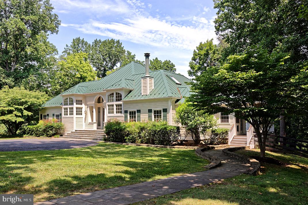 SUBSTANTIAL PRICE REDUCTION.     Find serenity on this 10 acre, Middleburg Hunt Country getaway.  Walk out the front door to your private horse paddock with a run-in shed.  Walk out the back door and access the Atoka Chase neighborhood walking and riding trail. In the spring meander through the fields of bluebells that sit along the banks of Goose Creek.  Enjoy a peaceful afternoon reading or visiting with friends or a quiet night star gazing from the brand new Trex deck which overlooks acres of protected countryside.  Located along the quiet Northern edge of the desirable Atoka Chase neighborhood, this property is less than a 10-minute drive from the historic village of Middleburg, accessible entirely via paved roads so sports car aficionados need not worry. For those wanting to keep in touch, this home is equipped with fiber 1GB high speed internet. 
This home provides spacious first floor living, including a first-floor primary bedroom with walk-in closet, and private bath with high ceilings, heated floors, luxurious soaking tub, and walk-in shower.  The kitchen is a chef’s dream with a six-burner stainless steel gas cooktop with grill and vent hood, a large island with granite  countertops, and plenty of cabinets and workspace.  Open to the kitchen is a bright family room featuring a gas fireplace, wall-mounted TV, and a built-in workspace.  Light pours into the kitchen and family room from all directions, combining with tall ceilings and light warm colors to create a relaxing and comfortable living area.  A formal living room sits adjacent to the kitchen and family room, with a gas fireplace, plenty of space for a sitting area and separate dining area, with views overlooking the covered deck and countryside beyond.    
Two guest bedrooms and an office are located upstairs, each with high ceilings and access to the upper-level deck that overlooks Goose Creek.  Keep an eye out for the bald eagles that nest in the trees just outside the windows of these upstairs bedrooms. 
 The property also includes a detached two car garage with workbench and a storage shed.   
Furniture included, if desired.  

The community of Atoka Chase is surrounded by serene views of mountains and horse farms with their open fields lined with stone walls. It also offers the convenience of charming Middleburg and is within 40 minutes of Dulles International Airport and 80 minutes of Washington, D.C.