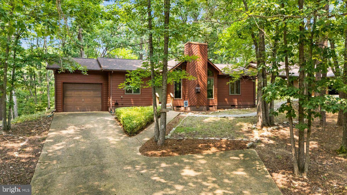 Contemporary single-level home set on a wooded lot. Vaulted beamed ceilings in living and dining rooms, renovated kitchen (2020) with granite counters and stainless-steel appliances, stone hearth and gas fireplace in living room, rear sunroom with large bay windows overlooking woods and leads to large wood deck updated and expanded in (2020). New vinyl flooring in sunroom (2020) All new exterior LP Smart Siding (2021). New washer & dryer (2022). Turnkey rental with established rental history being sold completely furnished. Located in the Massanutten community, a four-season resort with skiing, golf, hiking, mountain biking, indoor/outdoor waterpark, dining and many other amenities.