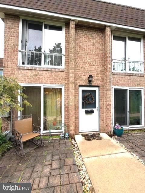 Comfortable 2 story townhouse set in the back of the  community  with a numbered parking spot and plenty of extras. There  is a large living room when you enter the home that has a lovely ceramic tile  half bath , large closet and adjacent breakfast area.  There is a sliding door leading  to a paver patio looking towards beautiful greenery. The kitchen has granite counters, ceramic tile floor, gas cooking, ample cabinets and a laundry /utility room attached with cabinets and shelves. Upstairs there is a nice ceramic tile hall bath, 2 spacious bedrooms and large closet. Vinyl plank flooring finishes out the home. The trash container is just a few steps down the walkway. There are bike racks and easy access to shopping very close by. Don't miss this opportunity to  own this gem tucked away in the back of an adorable community. Camera present.