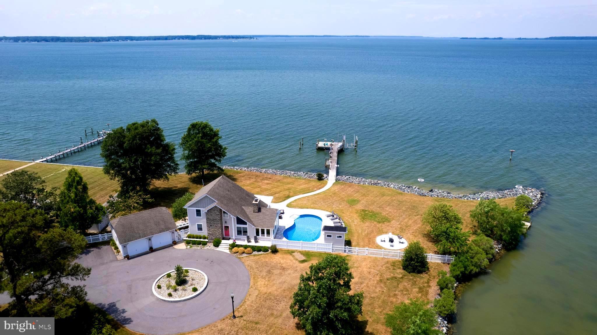 Welcome to Your Eastern Shore Waterfront Paradise! Nestled along the shoreline and designed for exceptional coastal living, this stunning waterfront retreat offers the perfect blend of luxury, recreation, and relaxation. Spend your days boating, kayaking, paddleboarding, or fishing from one of three private docks, complete with two boat lifts and a dedicated fish-cleaning station.

Outdoor living takes center stage with a solar-heated pool surrounded by elegant travertine marble, a fully equipped outdoor kitchen, and a pool house with a full bath—creating the ultimate setting for entertaining family and friends while enjoying breathtaking waterfront views and sunsets.

Inside, the thoughtfully designed open floor plan seamlessly connects the living spaces, highlighted by a gourmet kitchen and a striking double-sided wood-burning fireplace. The main level features a private guest suite with an ensuite bath, while the upper level is anchored by a luxurious owner's retreat offering a spa-like atmosphere, abundant comfort, and the convenience of a second-floor laundry room.

A detached two-car garage includes a separate propane heater and a walk-up unfinished second level, presenting excellent potential for a guest apartment, studio, or additional living space.

Conveniently located just 45 minutes from Annapolis and approximately one hour from the beautiful beaches of Maryland and Delaware, this extraordinary waterfront property offers a rare opportunity to experience the very best of Eastern Shore living.