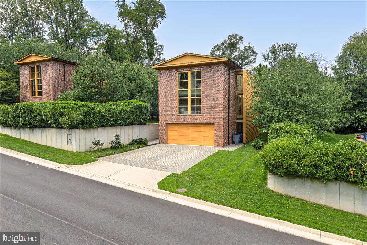 Welcome to this stunning contemporary home that combines modern design with the comforts of luxury living. Situated in a prime location, this property boasts numerous features that make it a dream home for anyone seeking style, convenience, and ample space.  As you step inside, you'll be greeted by soaring high ceilings that create a sense of spaciousness and grandeur, making the home feel even more expansive. Large windows throughout the home allow an abundance of natural light to flood the living spaces, creating a warm and inviting ambiance. The heart of this home is undoubtedly the chef's kitchen, equipped with top-of-the-line stainless steel appliances, sleek countertops, and ample storage, The main living area features an open floor plan, perfect for entertaining  or relaxing. The seamless flow between the living room, breakfast/dining area, and kitchen adds to the overall sense of openness. Revel in the elegance and practicality of all hardwood floors on the upper 2 levels, offering durability and easy maintenance while adding to the home's contemporary appeal. The lower level has concrete flooring.  Step outside to a  patio and flat yard, offering plenty of space for outdoor activities, or simply relaxing in the sun or shaded awing above the patio. Enjoy easy access to the highway, making commuting a breeze. You'll also find a nearby shopping center and various restaurants for your everyday needs and entertainment. The Washington and Old Dominion Trail is a few feet away. This contemporary masterpiece offers an unparalleled living experience for those who appreciate modern design and the convenience of a central location. Whether you're looking to entertain or simply relax in a bright and sunny space, this home has it all.