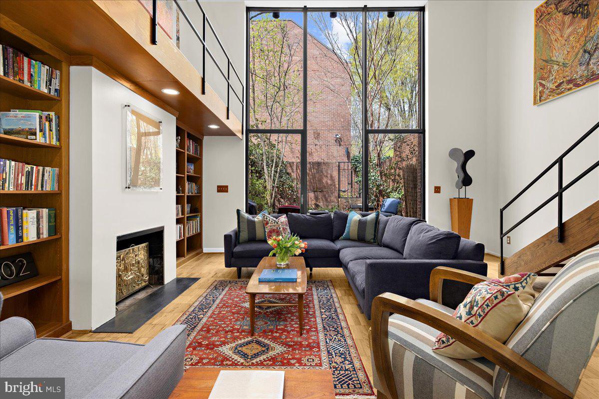 Architectural Masterpiece by Hugh Newell Jacobsen in the Heart of Historic Bolton Hill
Welcome to 302 W Lafayette Avenue, an exceptional townhome in the coveted Bolton Hill neighborhood, designed by internationally renowned architect Hugh Newell Jacobsen—celebrated for his iconic work on the Jacqueline Kennedy Onassis residence on Martha’s Vineyard, the American Embassy in Paris, and the extraordinary expansion of the U.S. Capitol complex.

This rare architectural gem provides 2,496 square feet of finished living space and features four bedrooms and three and a half baths, seamlessly blending clean-lined modernism with timeless sophistication. A private brick courtyard—complete with a tranquil koi pool, flowering trees, and direct access to the community greenspace—offers a serene outdoor retreat within the city.

The entry level welcomes you with a bedroom suite and full bath, a dedicated laundry area, and a stunning catwalk that overlooks the dramatic main living space. The living room, crowned by soaring two-story atrium windows, is bathed in natural light and anchored by custom built-in bookshelves and a wood-burning fireplace—a perfect setting for both quiet evenings and sophisticated entertaining. Expansive wall space invites the display of a curated art collection.

Upstairs, the primary bedroom is filled with natural light, accompanied by two additional bedrooms and a full bath. A finished attic level provides a quiet escape, ideal as a den, home gym, or creative studio, with ample storage tucked seamlessly into the design. Recent updates include new HVAC system in 2023, ductless system in attic in 2024, and new roof in 2021. 

Truly one of Bolton Hill’s most remarkable homes, 302 W Lafayette is a rare opportunity to live in a work of art by one of America’s most celebrated architects, all within minutes of cultural landmarks, private schools, and the vibrancy of downtown Baltimore.