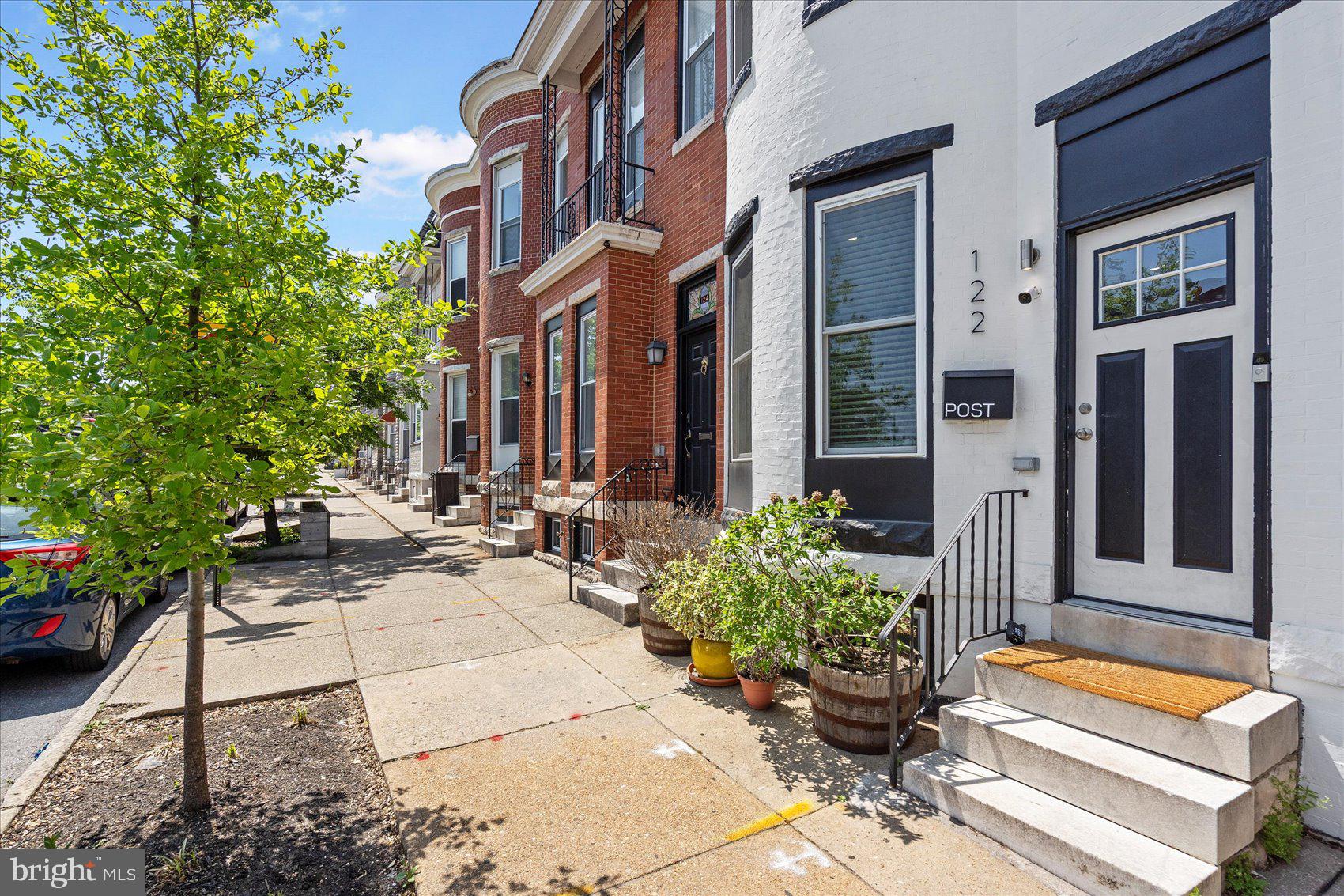 Welcome to 122 S Highland Ave – where modern updates meet classic Baltimore charm.
This fully renovated, move-in-ready rowhome offers 1,844 finished sq ft across three spacious levels in the heart of vibrant Highlandtown. Fully rehabbed in 2022, this 4-bedroom, 3.5-bath home blends contemporary design with timeless character. Step inside as you are welcomed into the bright, open-concept main level featuring recessed lighting, a stunning coffered ceiling, and a signature exposed brick wall that brings warmth and personality to the space. The chef-inspired kitchen boasts stainless steel appliances, quartz countertops, a sleek backsplash, spacious walk-in pantry, and  island with stylish pendant lighting—perfect for entertaining. A main-level powder room adds everyday convenience, while the dual-zoned HVAC system (2022) ensures year-round comfort. The roof was resealed in 2023, offering peace of mind.
Downstairs, the finished basement provides flexible living space—ideal for a home office, gym, or guest suite. Upstairs, unwind on your private Trex rooftop deck, where sweeping city views create the perfect backdrop for relaxing or entertaining. At the rear, enjoy private parking, with potential for easy conversion to accommodate two vehicles, depending on your needs. Don’t miss out on this incredible opportunity—contact the listing agent and schedule your tour today!