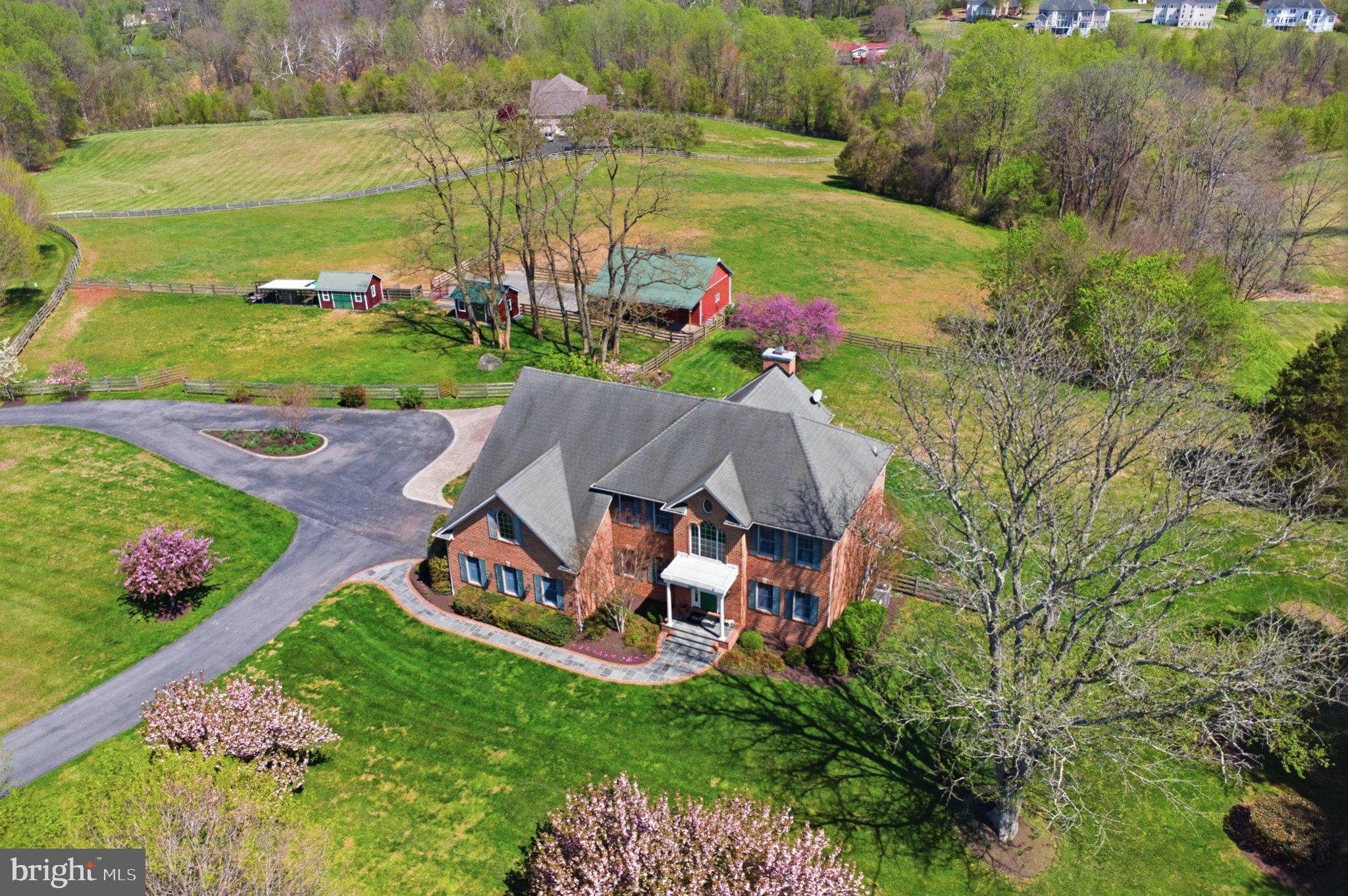 **Sneak Peek!** Coming Soon!** Picture-perfect 5.7 acre country estate in sought after Sandy Spring, ready for you to bring your horses home!

Maintained by its original owners, this classic brick Colonial was constructed in 2000 and offers a bright, open floor plan designed for both comfortable living and entertaining. The main level is highlighted by a dramatic two-story living room that opens directly to a large screened porch. The heart of the home is the spacious kitchen, featuring a center island and a casual breakfast area that flows effortlessly out to a large deck overlooking the beautiful, rolling pastures. A dedicated home office and a formal dining room complete the main level.

The upper level features a spacious Primary Suite alongside three additional bedrooms, a full bath, and a multi-function loft, including a closet perfect for kids’ board games. The finished basement provides even more living space, complete with an additional full bath finished at the time of construction and a French door walkout to a backyard patio. The basement also offers two adjacent storage areas, closed off from the finished lower level with standard door entries.

Step outside to take in the amazing pastoral views. The home sits perfectly, overlooking a highly private, one-acre backyard that is securely fenced—making it absolutely perfect for dogs! This big backyard seamlessly transitions to your pastures and a forested conservation area.
**The Equestrian Facilities:**
Designed for both the horse and owner in mind, the farm setup is incredibly functional and easy to manage.
* **The Barn:** A 3-stall barn that opens directly into a sacrifice lot equipped with all-weather footing.
* **The Pastures:** Three additional beautiful pastures, safely enclosed with classic 4-board fencing.
* **The Outbuildings:** Two matching carriage buildings dedicated entirely to hay storage and farm equipment.

Enjoy your own private equestrian oasis with unbeatable convenience. Not only are you located just 5 minutes from the Iron Bridge Pony Club, but you also have quick access to fantastic dining, shopping, and everyday amenities nearby in the charming communities of Sandy Spring and Olney!

Contact Camilla Cornwell or Ninja Nissen for more information or to schedule a tour.