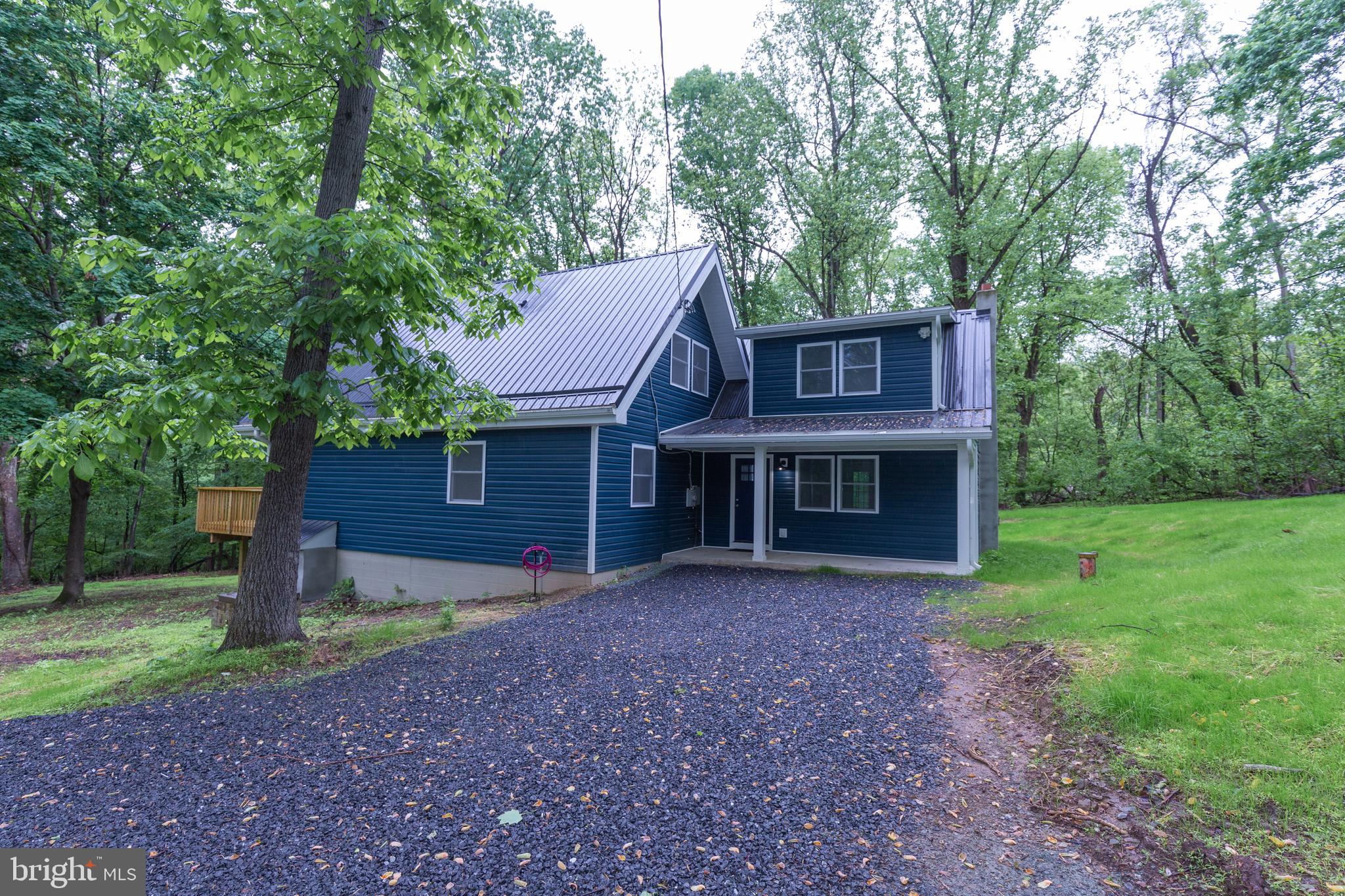Escape to your private mountain retreat in the Shenandoah Overlook neighborhood! This completely renovated contemporary single family home on a wooded lot offers a perfect blend of modern living and natural surroundings.

The front facade features floor to vaulted ceiling windows that bathe the open-concept living and dining area in natural light, face the large deck and offer a stunning view of the surrounding forest. The kitchen with stainless steel appliances is along a side wall - allowing you to cook and enjoy the view! 

You are welcomed by a comfortable family room with french doors to the unfenced yard. Up a staircase off of the family room is the first bedroom with full bath. As you walk into the open-concept living area there is a laundry closet with full sized washer and dryer, full bath, and additional bedroom. The third bedroom and full bath is in the loft overlooking the living area. 

This beautiful home is located on a dead-end road located off of Chestnut Hill Rd between US-340 and WV-9; just minutes to VA and MD border.

No Pets
Rent includes water and septic. 
Additional monthly costs include Renter's insurance (price based on plan selection) and Second Nature Air Filter Subscription program ($15.00/ month).