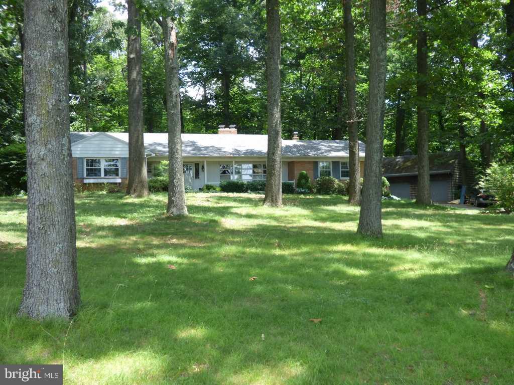 Looking for a place to tinker and be alone? Check out this rancher located on a private 2.2 acre wooded lot. Awesome 2-story, 24x38 detached garage with space for 2+ cars, storage, and workspace. Home is in need of some TLC, but has large rooms, wood-burning fireplace, woodstove, hardwood floors 1st and basement laundry hookups. New roof 2011, new septic 2012.