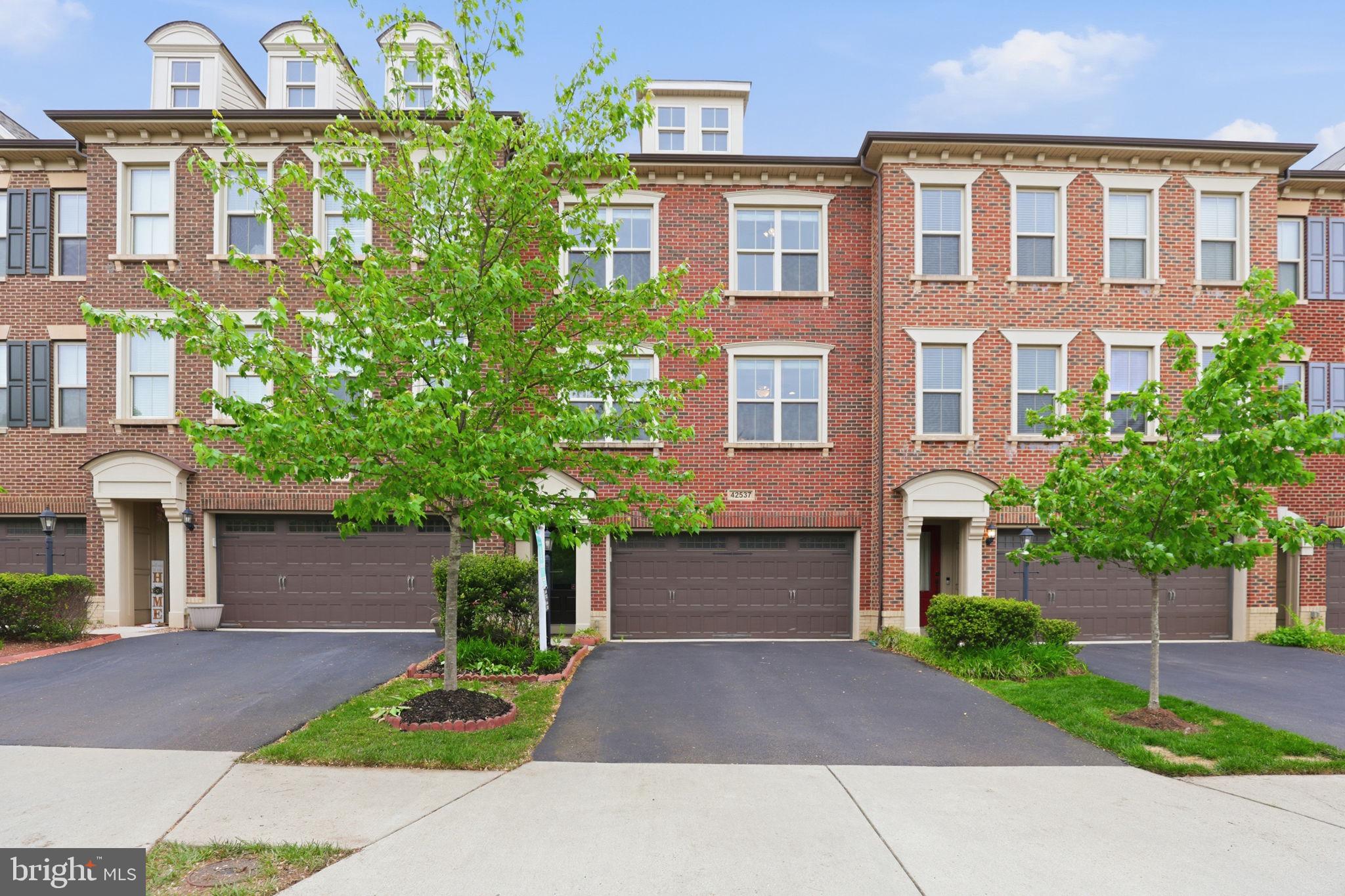 Step into a home where comfort, elegance, and everyday living come together beautifully. Nestled in the heart of Ashburn’s highly sought-after Brambleton community, this stunning Winchester Homes Paxton model with a 4-foot extension invites you to experience a lifestyle you’ve been waiting for.
From the moment you walk in, you’ll feel the warmth of a thoughtfully designed space that truly feels like home. The main level welcomes you with rich hardwood floors and an inviting flow—from the formal living and dining rooms where memories are made, to a private office perfect for quiet moments or working from home. At the heart of it all is the expansive family room, ideal for gathering with loved ones, seamlessly connected to a gourmet kitchen that will inspire your inner chef. Featuring a large center island, elegant cabinetry, granite countertops, stylish backsplash, and soft pendant lighting, this kitchen isn’t just functional—it’s where life happens. Step out onto the spacious deck and imagine morning coffee or evening sunsets in your own private retreat.
Upstairs, the primary suite offers a peaceful escape at the end of the day. Unwind in your spa-like bath with a soaking tub, glass-enclosed shower, dual vanities, and a generous walk-in closet designed to keep everything effortlessly organized. Two additional bedrooms provide comfort and flexibility for family, guests, or creative space, while the conveniently located laundry room makes daily living that much easier.
The lower level extends your living space even further, featuring a cozy recreation room with a fireplace—perfect for movie nights or relaxed weekends. With a full bath and walk-out access to a private fenced patio, it’s an ideal setting for entertaining or simply enjoying quiet outdoor moments.
Living in Brambleton means more than just a beautiful home—it’s a vibrant lifestyle. From scenic trails and parks to community events, shopping, dining, and top-tier amenities, everything you need is right at your fingertips. Plus, with easy access to major highways, Dulles Airport, and the Silver Line Metro, convenience is always within reach.

Unique Features That Set This Home Apart
Unlike many townhomes, this property offers a thoughtfully designed layout with a separate private office, perfect for working from home or quiet study. The main level features not just one, but distinct formal living and dining rooms, creating elegant spaces for entertaining—something rarely found in typical townhomes.
At the heart of the home is a spacious gourmet kitchen that opens seamlessly into a large, inviting family room, ideal for everyday living and hosting gatherings. Step outside to enjoy a generous deck for outdoor dining and relaxation.
The fully finished lower level includes a recreation room with access to a private backyard patio, providing additional space for entertaining or unwinding.
Upstairs, the home features a large primary suite designed for comfort, while all bedrooms boast vaulted ceilings, enhancing the sense of space, light, and architectural charm throughout.
This home truly offers the space and functionality of a single-family home with the convenience of townhome living.

This isn’t just a home—it’s where your next chapter begins.