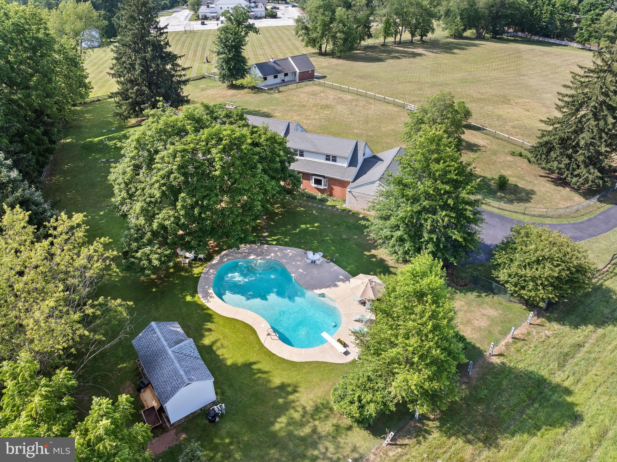 Spacious and solidly built, this Cape Cod home is a blue ribbon property has a very desirable location and many amenities. Set on five peaceful and private acres, the flexible floorplan fits all your needs!  Front porch is perfect place to enjoy sunrises & sunsets, & watching animals in front 3 acre pasture, with two acres around the house fenced with wire to keep smaller pets and tots safe.  On first floor is a large bedroom with four handy closets and a large tile bath. Across the hall is an additional bedroom with ensuite bath. These bedrooms are adjacent to a wood-paneled den on back of house, with thermostat controlled pellet stove insert in fireplace, surrounded by brick wall, and a raised brick hearth makes it cozy in winter.  The sliding glass doors open to the screened porch with skylights and ceiling fan and a truly fabulous  view of pool, pool shed, and fenced yard.  Sunsets and moon rises over the long view of rolling hills at Flintlock Farm that have been enjoyed sitting by the pool are amazing! The den opens to a large living room on the front of the house, with built-in shelves and cabinets on one wall and views out front through floor-to-ceiling windows. Across from the living room, an entry hall opens to a dining room with large picture window, looking out to the front porch and pasture.  The dining room also opens to the kitchen with pantry, butcher block island, and breakfast area with floor-to-ceiling windows.  The kitchen leads to a laundry room with new LG washer and dryer, and the laundry has door to front walkway. Saving the best for last is the front-to-back great room, with wet bar and grill top, back stairs to the second floor,  a door that leads out to the pool, and another door into large 3-car garage with overhead attic. The center entry hall opens to the kitchen, screened porch, powder room, den, and the main stairs to the second floor.  At the top of the stairs, there is a master suite with large closet, leading to a dressing area with full bath and large closet,  with the flow going into a bedroom with closet, and access to back stairs down to the great room, as well as a small attic for storage. At the other end of the house, the hallway has a cedar closet, full bath, two more spacious bedrooms, and access to a large attic. Plaster ceilings and walls, as well as hardwood floors and solid wood doors are found in the majority of the home.  A very rare bonus is the three stall barn, with large hay/tractor storage room, and tack/feed room on ground level, hay loft that holds at least 1.5 tons of hay above, and three acres of lush, fenced-in pasture. Good potential for AirBnB, where guests can bring horses to enjoy miles of trails at Valley Forge, Marsh Creek and Ridley Creek Parks, and many local horse shows, such as Devon and Ludwigs Corner, as well as Radnor Hunt.  Other upgrades include new driveway; septic system designed for six bedroom home; new well pump, pressure tank, and line to house; rebuilt chimney for family room fireplace with thermostat-controlled pellet stove insert, new oil furnace as back up to new heat pump, and spray-foam insulation in attics and basement crawl space walls make this home energy efficient.  Pool upgrades include new Hayward D.E. filter, variable speed pump, pipes and valves, and a Dolphin self-cleaning vacuum.  Minutes from this desirable location on Valley Forge Mountain is the R-5 train station in Paoli, restaurants and shops in Phoenixville, public golf courses, King of Prussia Mall, and the Main Line.  Easy access to Philadelphia and the airport, as well as ramps to PA Turnpike at Valley Forge and Great Valley CC.  Walk to YMCA and Schuylkill Elem. in awardwinning Phoenixville school district.  Convenient to it all, but hidden from the hustle and bustle of daily life is truly what makes “Hidden Hillview” special and valuable.  please don't enter the driveway without an appointment.