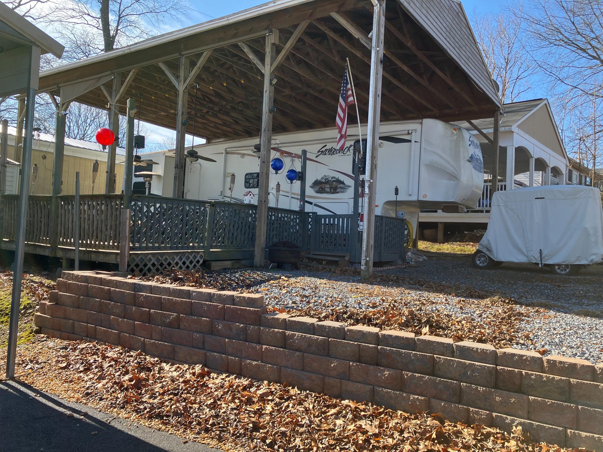 2015 gas EZ-Go Golf cart is included in the price!   Are you looking for a place to relax on the weekends?   Block 25 Lot 8 on Poison Oak is a wonderful camping lot close to all the amenities that River Bend seasonal campground has to offer.   This lot includes a large 2-Bedroom ,1.5 bath 2011 5th wheel Silverback Cedar Creek camper that sits under a very large pavilion.  The camper has a primary bedroom with a queen bed, plus an additional bedroom with 3 bunkbeds.  Also included in the list price is the 2015 gas EZ-Go Golf Cart shown in the photos, but if you don't need a golf cart, the price can be lowered.  There's a large deck with room for hosting and relaxing.   

This lot is on sewer, which means no worries about ever pumping out the tanks!  The shed has electric and comes with a full-size refrigerator inside.  Included with the sale you'll get multiple TV's, an outdoor propane heater, gas golf cart, outdoor speakers, 2 grills, a small outdoor refrigerator, a picnic table, and a camera system.  There's ample parking for cars, golf cart, boat, etc.   

River Bend Campground sits along 12 Miles of deep water on the Potomac River.  Great for boating, fishing & swimming. Yearly membership includes water, sewer, electric, trash and all the park amenities that River Bend has to offer.  All 2026 Dues are already paid in full.  Enjoy 3 pools, putt putt, horseshoes, basketball, tennis, fireworks, car shows, a restaurant/bar, laundry facilities, playgrounds, ball fields and much more.

 Call for your tour today!