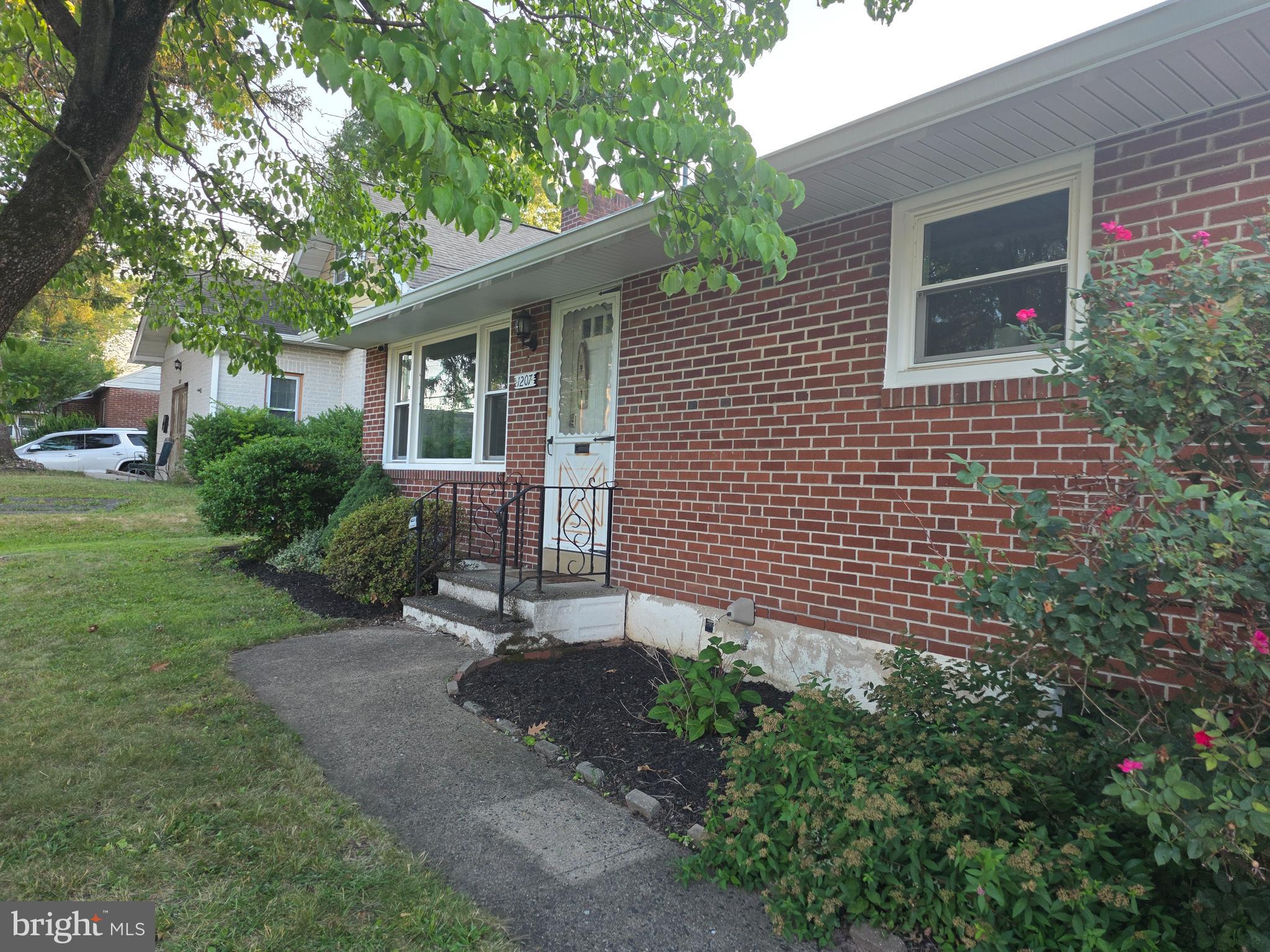 Cute brick‑front ranch home with a one‑car garage on Pottstown’s North End. This well‑kept property offers two large bedrooms with ample closet space and an inviting eat‑in kitchen with a breakfast counter. Hardwood floors flow through the main living area, highlighted by a wall of windows and your first fireplace.
The lower level is divided into two functional spaces: one side is ready to be finished and features the second fireplace, while the rear section includes basement stairs, laundry, and an open‑air bath with shower and toilet — a layout regionally known as a Pittsburgh bathroom.
The home sits nicely off the street and includes a fenced rear yard with a cement patio, perfect for outdoor enjoyment. A covered side porch off the driveway serves as the convenient daily entrance.
Major renovations within the last few years include new roof, gutters and downspouts, windows, and heating/air conditioning system. With solid mechanicals and exterior upgrades already completed, you can simply add your preferred interior colors and move right in.
This charming ranch offers comfort, updates, and a great location — a wonderful opportunity to make this home your own.