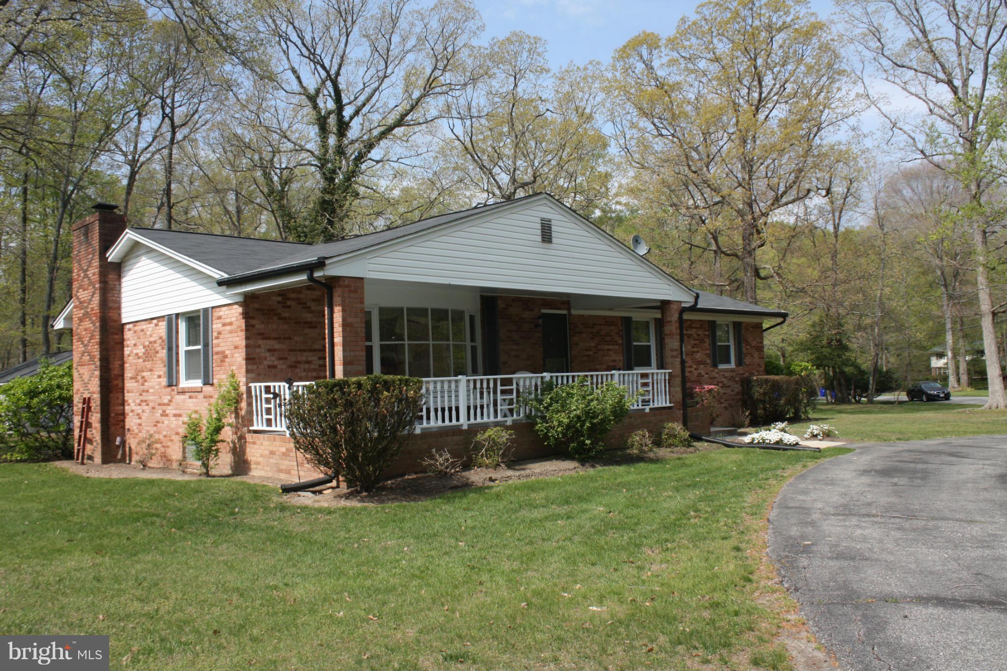 Classic brick rambler with charming surprises....great sunroom off large kitchen overlooking mature azaleias; circular driveway in front; large southern front porch, sunny bay window in living room, built in shelving with window seat; entertainment bar; cozy fireplace with mantel; newly installed carpet; freshly painted.  Estate sale..detached garage/workshop w/electricity. Public water & sewer.