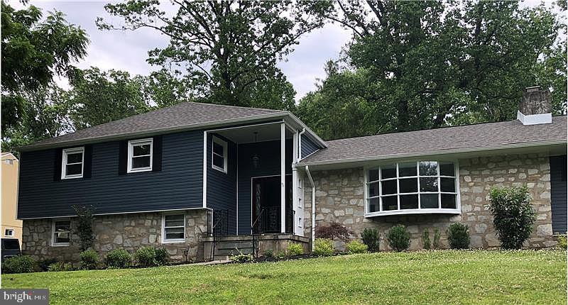 Completely renovated and move-in ready, this beautifully updated 4-bedroom, 2.5-bath split-level sits on just under an acre of mature, professionally landscaped grounds in the popular Brentwood Manor neighborhood and the award-winning Abington SD.  Comprehensive 2019 renovation, the home boasts a new roof, a new high-efficiency heating system with newly added gas service, central air conditioning, an all-new gourmet kitchen with crisp white cabinetry and updated appliances, and all-new bathrooms. The first floor was opened into one expansive great room anchored by a dramatic stone wood-burning fireplace, flowing seamlessly into the dining area and bright eat-in kitchen — ideal for both everyday living and effortless entertaining. A welcoming entry foyer, an oversized private office, and a glass-enclosed sunroom that opens onto a new flagstone patio add wonderful flexibility and charm, with serene views of the surrounding greenery and wildlife. Upstairs, the tranquil primary suite features a brand-new custom en-suite bath, along with three additional generously sized bedrooms and a full hall bath. The dry, high-ceilinged basement spans the entire footprint of the home, delivering tremendous storage and expansion potential, while a convenient main-level bonus room with a stylish half bath and lower-level laundry round out the thoughtful layout. An oversized two-car attached garage with direct interior access, plus two private driveways, provide ample parking. Perfectly positioned minutes from Huntingdon Valley Country Club, premier shopping and dining, top hospitals, parks and walk/bike trails, and major commuter routes, this turnkey home is a rare blend of elegance, comfort, and an unbeatable location.