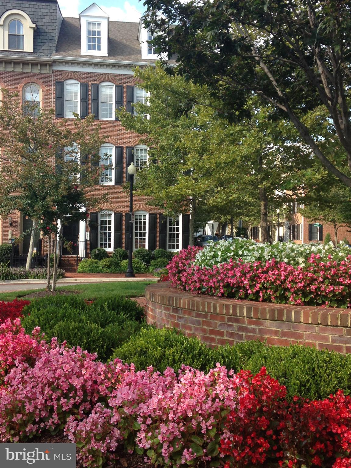 Welcome to 1716 Potomac Greens Drive, a stunning, sunfilled end-unit in the highly sought-after Potomac Greens neighborhood in Old Town,
Alexandria. Overlooking the newly finished circle garden, this four-story townhouse enjoys
a prime location; a close proximity to shops and restaurants at one end of the street and
the brand-new Potomac Yard Metro station at the other. Loaded with high-end upgrades
and designer finishes, this home exudes elegance and charm. A stately stone fireplace is
the centerpiece of the open concept first floor, where sun pours in throughout the day,
showing off gleaming new hardwood floors. The main living level boasts a wall of built-ins
and a double-sided fireplace between the formal dining room and sitting area. The spacious
kitchen is designed for both cooking and entertaining, featuring ample counter space and a
seamless flow into the living and dining areas. The powder room is a show-stopper with
designer wallpaper, paint, wainscoting and finishes. Three bedrooms, two full baths and a
laundry room on the third floor make a great layout for families with children. Tranquil
colors in the primary bedroom complement designer wallpaper/paint in the bath, making
the primary suite an awaited retreat. The suite also includes professionally designed hisand-hers closets. Enter the sun-filled open-concept fourth floor with double French doors
leading to a private balcony offering glorious sunsets and a bird’s eye view of the
neighborhood. Brand new beautiful (and soft) wool carpeting, a half bath with potential for
conversion into a full bathroom. A wet bar with a built- in refrigerated kegerator complete
this relaxing 4th floor oasis. In addition, the house is equipped with: • New heating/cooling
systems • Plantation shutters and designer fabric shades throughout the house. • New
hardwood floors on first level, new wool and wool blend carpeting on stairs, primary
bedroom and family room. • Newly painted walls. • Garden sprinkler/irrigation system • New
refrigerator, dishwasher, and clothes dryer • Built-in refrigerated kegerator in wetbar • Two
storage closets and above storage racks in garage • Gas hookup for gas grill on balcony •
Updated hardware • 10’ ceilings and 12” crown molding • Two fireplaces • Professionally
designed closets Community amenities including a clubhouse, outdoor heated pool, fitness
room, meeting/party room, biking/walking trail, pocket parks and tot lots, and the
neighborhood is adorned with tree-lined streets and brick sidewalks. In addition to the
brand-new Potomac Yard metro stop, Potomac Greens is adjacent to the George
Washington Parkway and Mount Vernon Bike Trail, a short distance to Reagan National
Airport, near Amazon HQ2 and the Virginia Tech Innovation Campus.