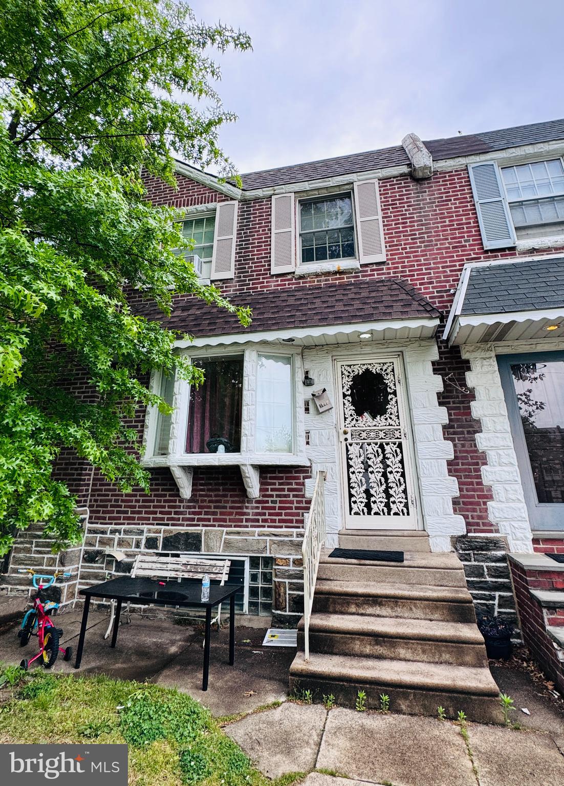 Welcome to this spacious 3-bedroom, 1.5-bath brick row-home located in the heart of Mayfair! Conveniently situated near supermarkets, schools, playgrounds, shopping, and public transportation, this home offers both comfort and accessibility.  Step inside to find a large living room with hardwood flooring, formal dining area, and an updated kitchen with ample cabinet space and access to a huge rear deck — perfect for entertaining, grilling, or relaxing outdoors.  The second floor features three generously sized bedrooms and a full bathroom with great natural light throughout. The finished basement provides additional living space, a powder room, laundry area, and direct access to the rear driveway and garage parking.  Great opportunity for both homeowners and investors alike!
