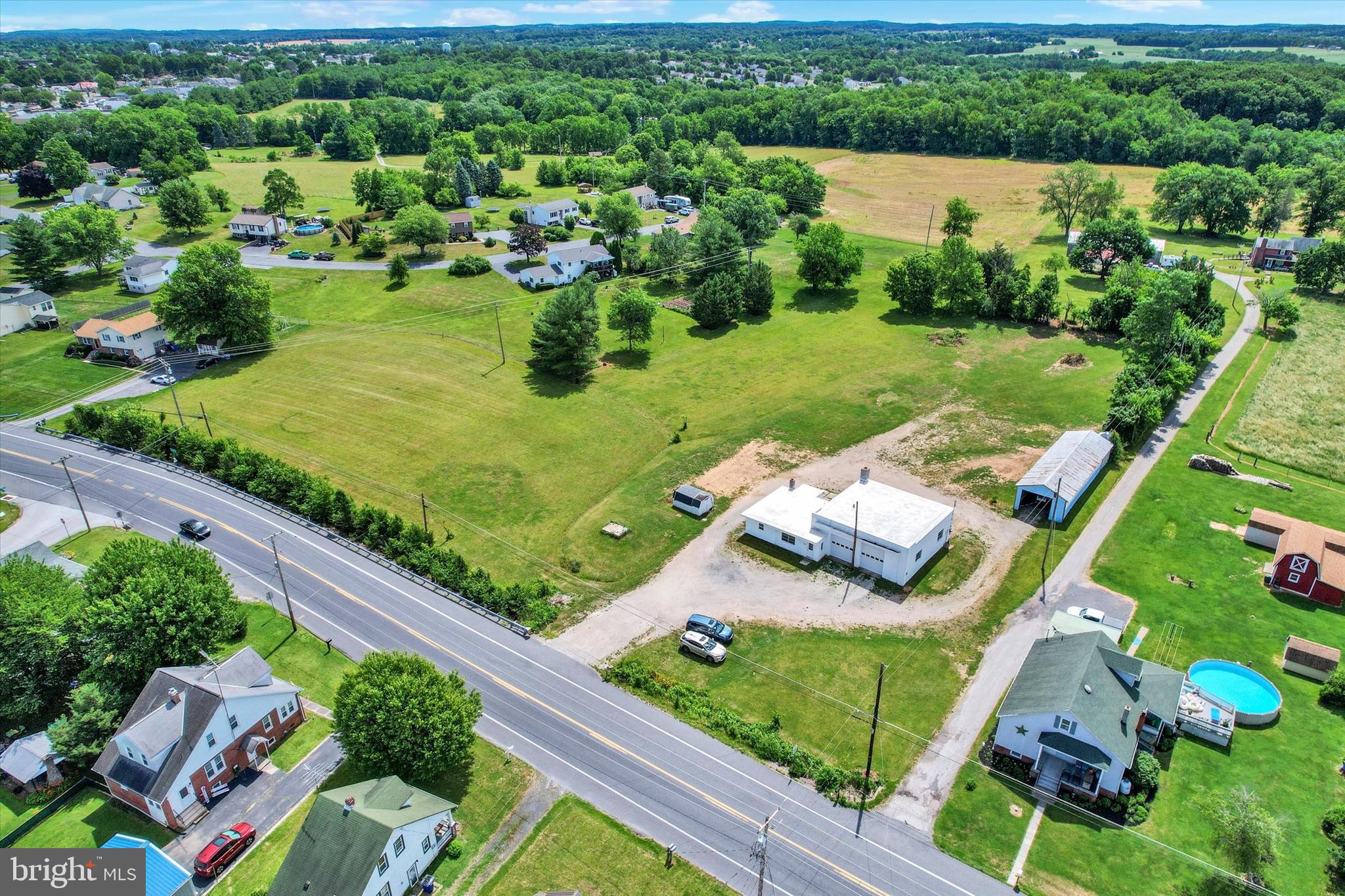 Bring your business and possible home to this 5.66ac property.  Large workshop building with some equipment (10 Ton chain hoist, and a 2-1/2 ton chain hoist).  2 Modine heaters, that will need hooked back up, a pellet stove to keep you warm.  Brand new PVC roofing with warranty.  Living quarters in back of shop, but will need some work.  Other buildings on property for storage.   Possible subdivision with township approval.  Two separate areas attached to roadways