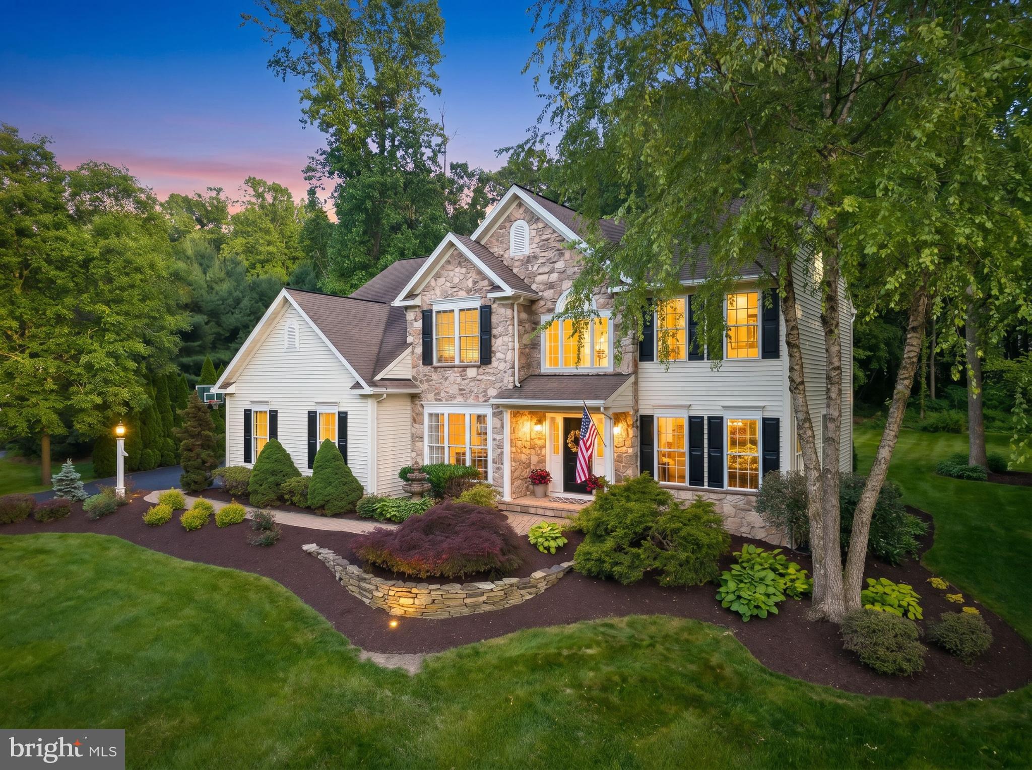 100 Pine Tree Drive is a beautifully maintained and thoughtfully upgraded 4-bedroom, 2.5-bath home nestled on a picturesque lot in Honey Brook. Combining timeless elegance with exceptional outdoor living, this property offers the perfect balance of comfort, functionality, and natural beauty.

Step inside to discover a dramatic two-story family room featuring soaring vaulted ceilings, a stunning floor-to-ceiling stone fireplace with raised hearth, and an impressive wall of windows that fills the home with natural light while showcasing views of the backyard oasis. Elegant crown molding and classic wainscoting add character and architectural detail throughout the home.

The spacious layout includes a private home office, ideal for today's work-from-home lifestyle, as well as a large unfinished basement offering endless possibilities for future expansion, recreation, or storage. A convenient two-car garage provides additional flexibility and practicality.

The primary suite serves as a private retreat, highlighted by a vaulted ceiling, elegant crystal chandelier, generous walk-in closet, and custom organizational systems designed for both style and functionality.

Outside, the property truly shines. The professionally designed and meticulously maintained landscape features more than 25 varieties of perennial flowers, flowering shrubs, and mature trees that create a breathtaking succession of color from spring through fall. Thoughtfully curated plantings attract butterflies and pollinators, enhancing both the beauty and ecological value of the grounds. In recognition of its habitat-friendly design, the property has been certified as a wildlife habitat by the National Wildlife Federation.

An expansive upgraded patio creates the perfect setting for entertaining, outdoor dining, or simply relaxing while enjoying the tranquil surroundings. Framed by mature landscaping and an incredible backyard, this outdoor retreat offers privacy, beauty, and year-round enjoyment.

Additional features include a VACUFLO whole-house central vacuum system with outlets throughout the home, garage, and basement, helping maintain a cleaner, healthier living environment by removing dust, dirt, and allergens from the home.

Offering exceptional indoor and outdoor living spaces, thoughtful upgrades, and one of the area's most captivating landscapes, 100 Pine Tree Drive is a place you'll be proud to call home.