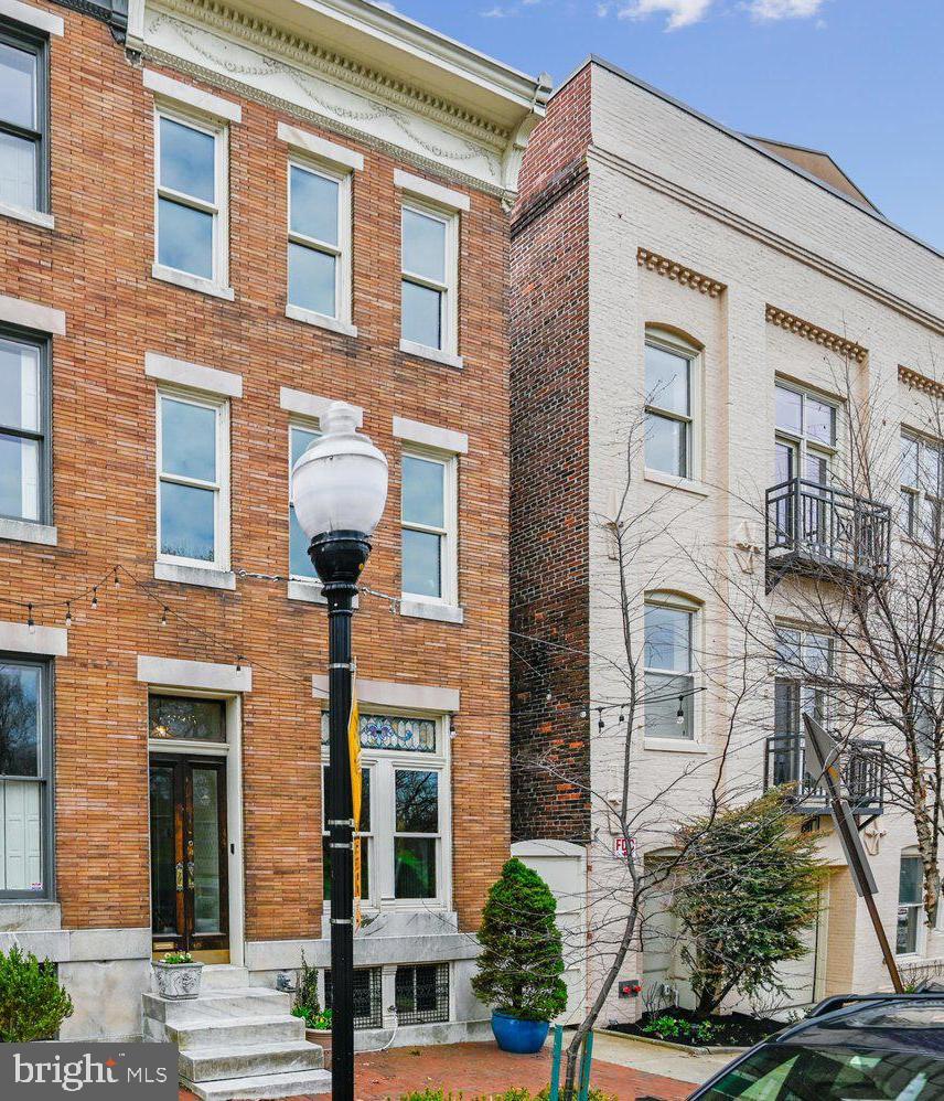The best of what city living has to offer. 335 Warren Ave is a refined four-level townhome on a rare non-through street directly across from Federal Hill Park, with its own private oasis plus garage parking! This home offers a mix of the old and new, with original details such as marble steps, hardwood floors throughout, and interior window shutters. You will also notice the original tiled vestibule as you enter the foyer, offering a lovely living room to the right. This bright room features a huge window overlooking the park, framed in stained glass, making it picture-perfect. Walk further, and you have a choice: go straight into an oversized dining room perfect for entertaining, or continue up the beautiful wood-framed staircase with its original ornate details. Choosing the first path will take you into the back of the house, which first provides a large coat closet and a ½ bath, before getting to the sun-drenched gourmet kitchen featuring stainless steel appliances and quartz countertops. From here, you can step out to a deck with a retractable awning to enjoy your morning coffee, overlooking a koi pond and several beautiful garden beds. Back inside and up one level, you will find 2 bedrooms, a large open flex space, a hall bathroom, and a laundry area. The seller currently uses the front bedroom as their family room to enjoy the park views. Up another flight is the primary suite. The entire floor is dedicated to a roomy bedroom overlooking the park, along with a large ensuite bath and multiple custom closets. This level also offers access to the multi-level rooftop decks with panoramic views of the city, park, and harbor. Perfect for entertaining and enjoying the fireworks! The full-size lower level provides a great amount of storage. And don’t forget, the coveted garage parking! This one ticks all of the boxes for comfortable city living.