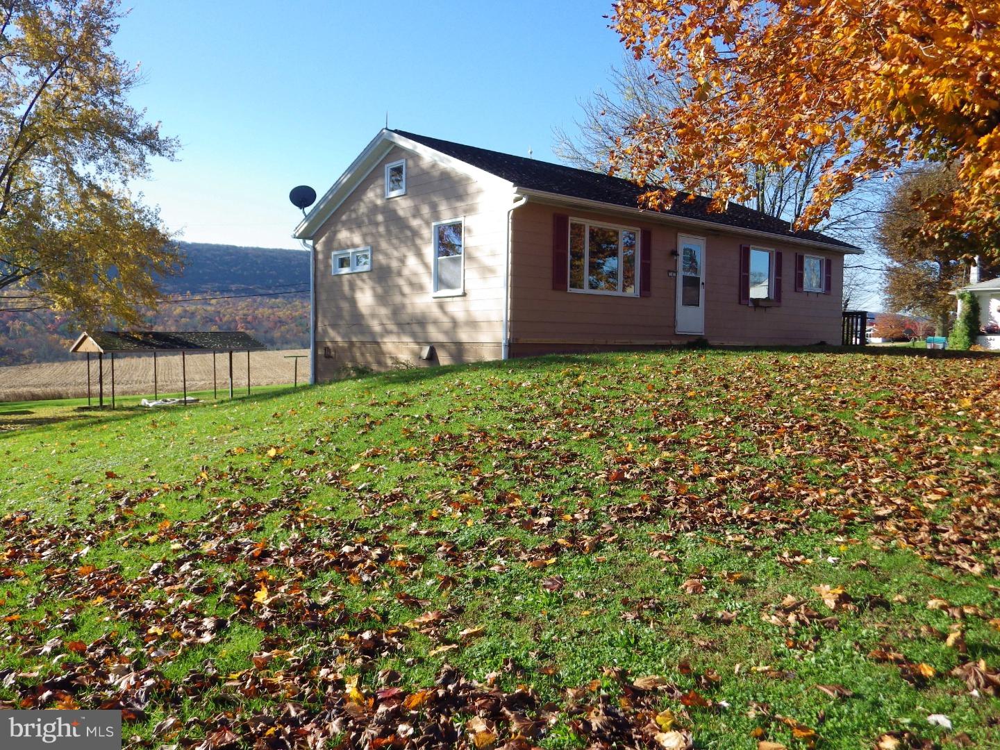 Move right in to this custom built Ranch in the beautiful Hegins Valley.  Situated on .41 acres there's plenty of room to enjoy the views from the back porch. This property features so many great amenities including a quiet street, corner lot, private driveway, storage shed, pavilion area, walking distance to local community pool, ball fields, and so much more! On the main level which consists of 960 sq ft. you will find the eat-in kitchen, living room, main bathroom with large linen closet, and two bedrooms with ample closet space. Don't miss the attic with plenty of storage. Newer flooring throughout with hardwood underneath. Venture downstairs to find the 572 sq ft of bonus space with its own heat, kitchen area, bathroom amenities, fireplace, and private entrance. Potential for a third bedroom. The attached 1-car garage with opener can also be accessed through the lower level. With two permanent heat sources to choose from you don't have to worry about getting chilly on those winter nights.