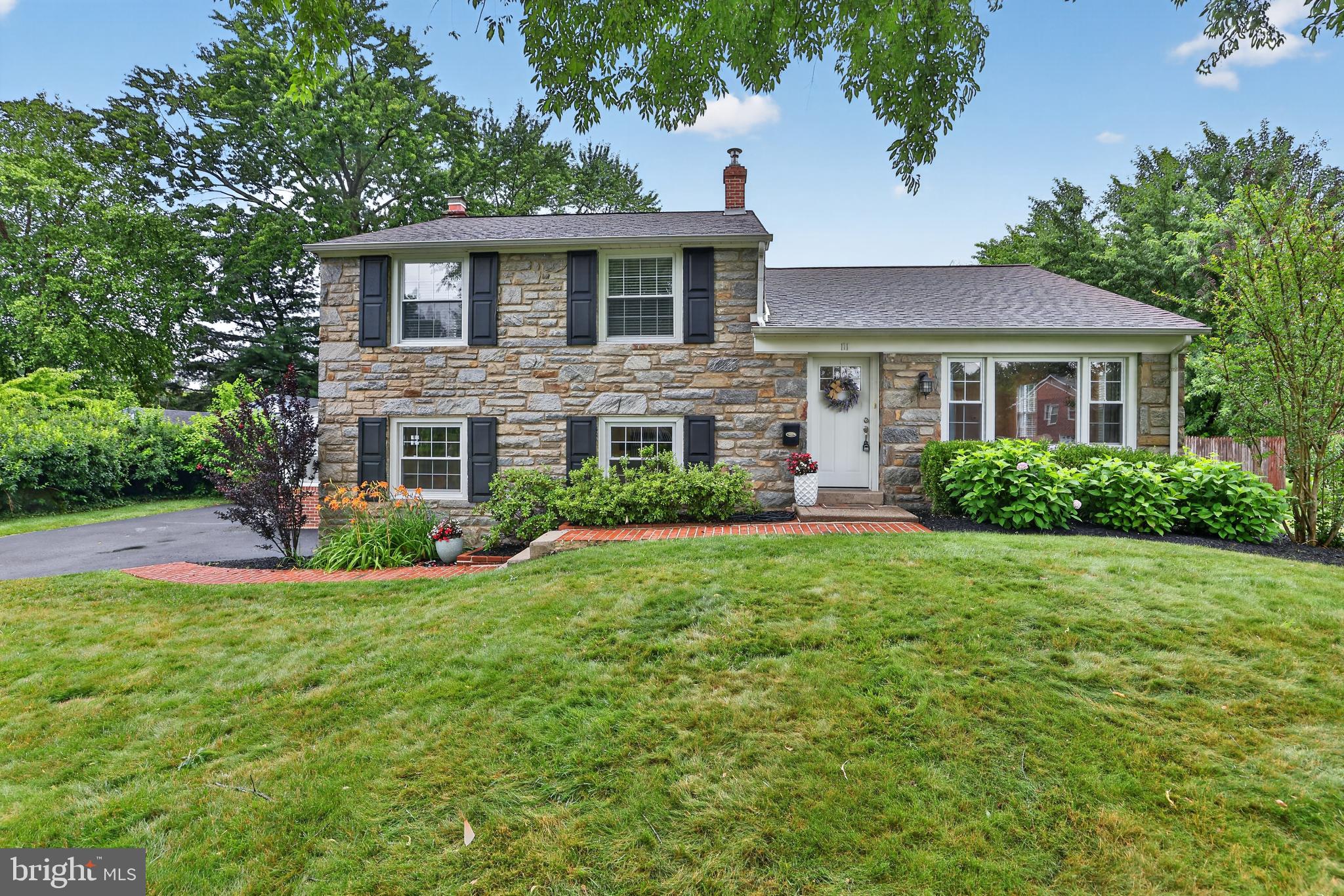 Welcome to 111 Canterbury Drive in the highly desirable Sproul Estates! As you approach this stately looking split level, you'll notice the impeccable landscaping and brick walk way. Step inside into your Living Room, which has hardwood flooring, recessed lighting, spacious living area, and an inviting layout designed for both everyday living and entertaining! The kitchen features white cabinetry w/ slow close doors, granite countertops, subway tile backsplash, and stainless steel appliances! The Dining Rm wall has been taken down, so you can cook and see your guests at the same time. Upstairs there are 3 updated bathrooms, generous in size & each bedroom has custom closets & ceiling fans!! The finished lower level family room has brand new carpet & stunning stone fireplace, powder room & laundry room! Off of the Family Room there is a three season room-perfect for those perfect for the summer nights! Outside, enjoy the level rear yard—perfect for outdoor entertaining!  The homeowners have done so much work to make this backyard a great Oasis with newer slider doors off of the Dining Room which leads to the paver patio, that overlooks a spacious back yard that is fenced in with a newer shed & great landscaping! There is a one car attached garage and ample driveway space. This home is situated just minutes from the vibrant downtowns of Swarthmore and Media, you'll enjoy easy access to local shops, restaurants, parks, and community events. Major roadways are nearby, making commuting to Philadelphia, Wilmington, and surrounding areas simple and convenient. Located in the award-winning Wallingford-Swarthmore School District!  Don't miss this opportunity to own a wonderful home in one of Delaware County's most sought-after communities. Schedule your private showing today!