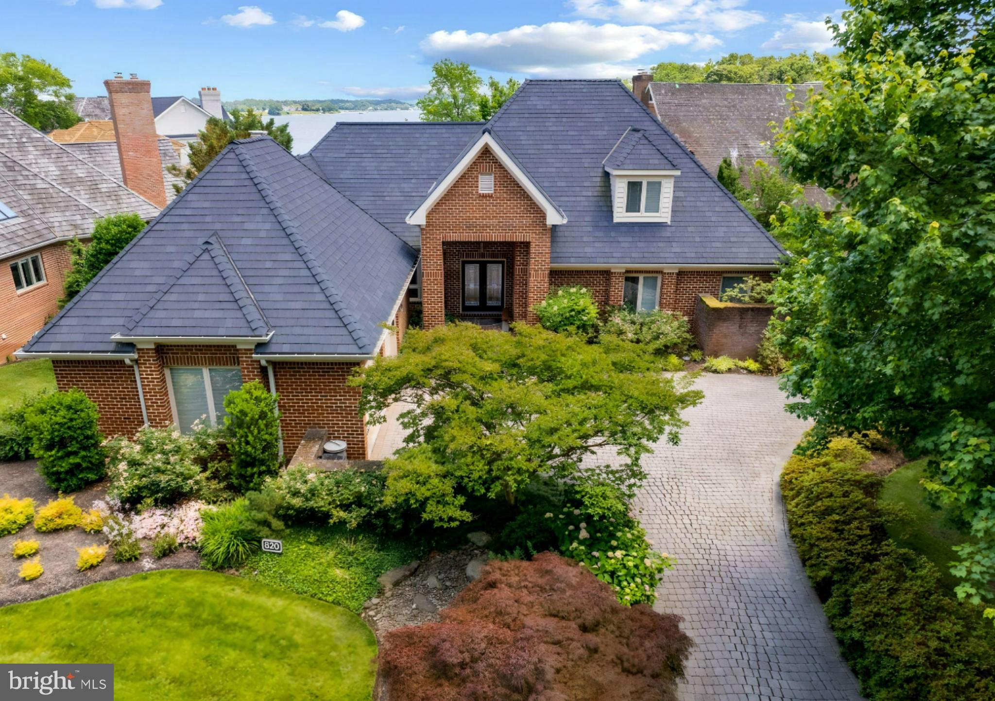 Enjoy resort-style living in this lovely brick home with peninsula views of the South River and Almshouse Creek and first right of refusal to purchase the deeded deep-water boat slip (sold separately).  This distinctive 5,300+ sq ft home showcases a lofty 2-story great room, 4 masonry fireplaces, main level primary suite with luxury bath, waterfront deck and shady covered patio.  Each upper level bedroom offers ample closet space and a private granite vanity area connected by a Jack-and-Jill bathroom with step-in shower/bathtub.  The lower level floor plan is flexible for a variety of uses and currently highlights a 2nd family room, huge den and library/4th bedroom, and access to a covered waterfront patio to the grassy lawn. Generous storage rooms and closets are found throughout.  50-yr composite roof installed in 2011 with warranty transfer to new owners.   The chairlift has been removed.  The community assn fee covers your lawn mowing, mulching, trimming and snow removal while also maintaining the 42-slip marina, swimming pool, tennis courts, playground, nature path and 24/7/365 staffed gated security.  Boat slip sold separately for $49,000.