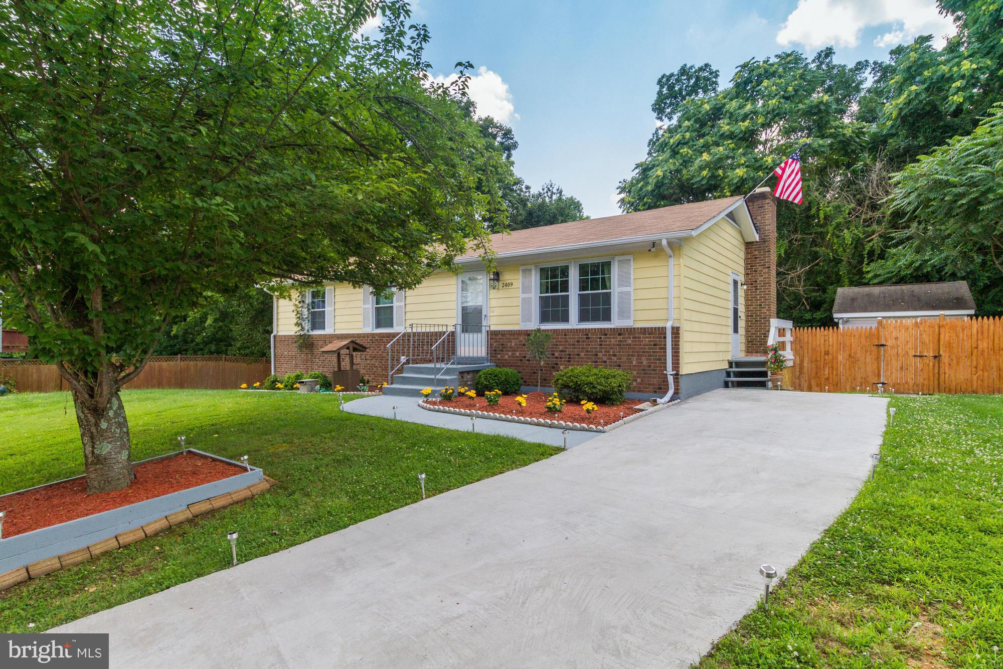 Gorgeous updated Rambler with tremendous curb appeal and charm.  Completely redone with too many upgrades to list. Newer roof, windows, doors, kitchen, appliances, hardwood flooring, updated bathrooms and fixtures. Completed finished basement with bonus room, full bath and fireplace. Bright and open with set up for in law suite. New fence and large deck  to very private wooded lot. Must see!