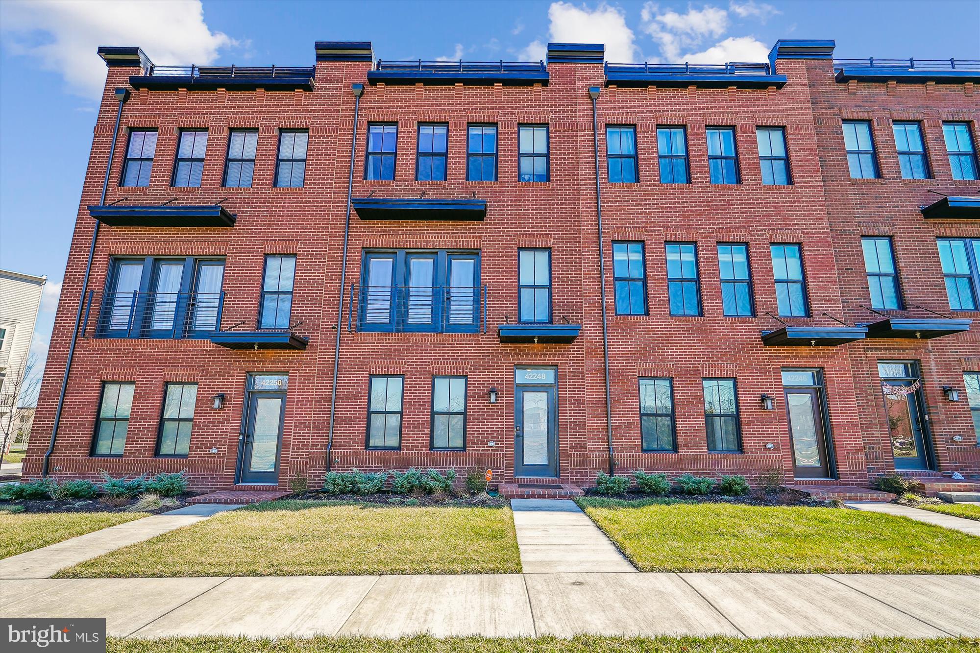One year old and Northwest facing Brambleton townhouse that feels like a single family, 5BR/4.5BA, with a bedroom and full bath on main level, an additional bedroom and full bath on top level, and a rooftop with a great an unobstructed view.   Top Schools!  NO PETS/NO SMOKING/CALL AGENT TO SCHEDULE SHOWING. Rent includes internet/cable service, trash removal, yard maintenance and access to Brambleton amenities.  This beautiful townhome is practically brand new, with tons of upgrades, large rec room on top level, full wall pantry cabinets in upgraded gourmet kitchen, built ins in closets, window treatments, high tech monitoring security system, and 2 car garage with custom floor coating and additional custom shelves plus 2 car spaces on driveway! This property is ideally located within walking distance (0.5 mile) of Brambleton restaurants, movies, park, etc. walking distance (0.4 mile) to Hal & Berni Hanson Park and only 3.5 miles to Ashburn Metro Station.  Check out virtual tour with floor plan!  PROPERTY ALSO LISTED FOR SALE. Rental Application Process in documents.