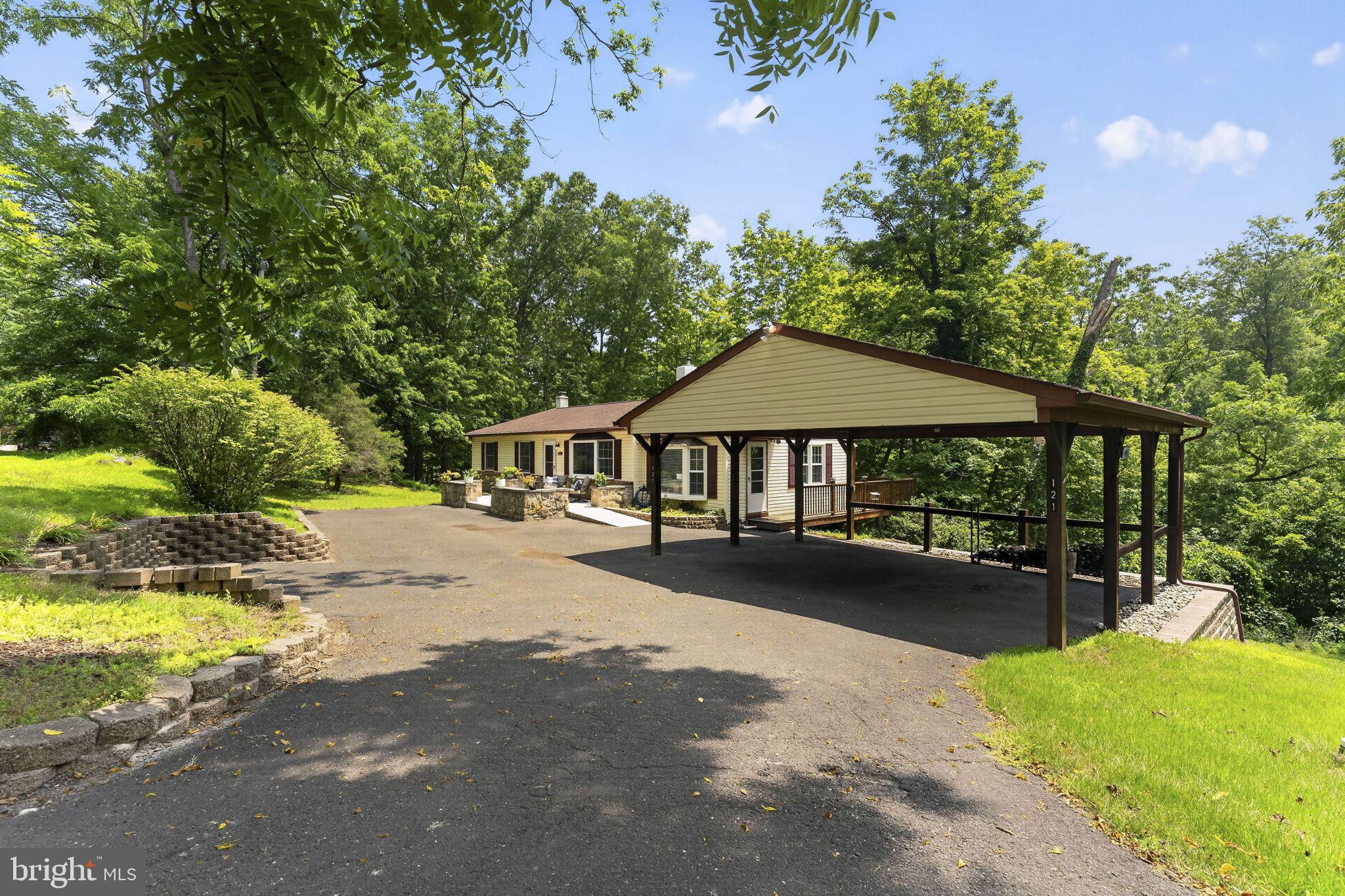 Welcome Home!  Wake up to ever changing seasonal vistas that rival a mountain retreat!  Located close to major roadways, shopping and entertaining yet tucked away on it's own private sanctuary you'll love the elevated views and undulating terrain surrounded by wildlife and nature at it's finest.  This ranch home has been meticulously maintained as pride in ownership is everywhere you look.  The newer roof with leaf filter butter protectors, newer water heater, newly renovated car port, a B-Dry basement, and even an entire whole house water filtration system with UV light already installed.  The unfinished basement is ready for your creativity with bright and airy windows and sliding doors open to the scenic backyard.  Upstairs head into the real retreat where you can really  the feel of tranquility of inside and out.   2 decks, one of which opens into a sunroom detailed with wood beams, a skylight, window nook with surround built-ins and also access to the attached car port would make an excellent outdoor entertaining space.  While the second deck offers a private space to relax, Read a book, enjoy the sun, bird watch and take in the wildlife on your own Juliet Balcony off of the Primary Bedroom with a half bath.  2 other bedrooms and a completely renovated hall bath will be found down the hallway and off of the main living areas.  The Kitchen offers the chef of the home plenty of space to get creative for hosted events and for everyday living.   Stay cool in the warmer summer months with central air conditioning and ceiling fans!  The cooler months you'll stay warm with the wood burning brick surround fire place with a recently cared for chimney in the welcoming living room.  The hardwood floors, arched entry way and this superbly cared for home and property offer a special opportunity for it's new homeowner.  See it live for the first time in over 30years on Thursday 7/23 at the Twilight Open House from 5-7!
