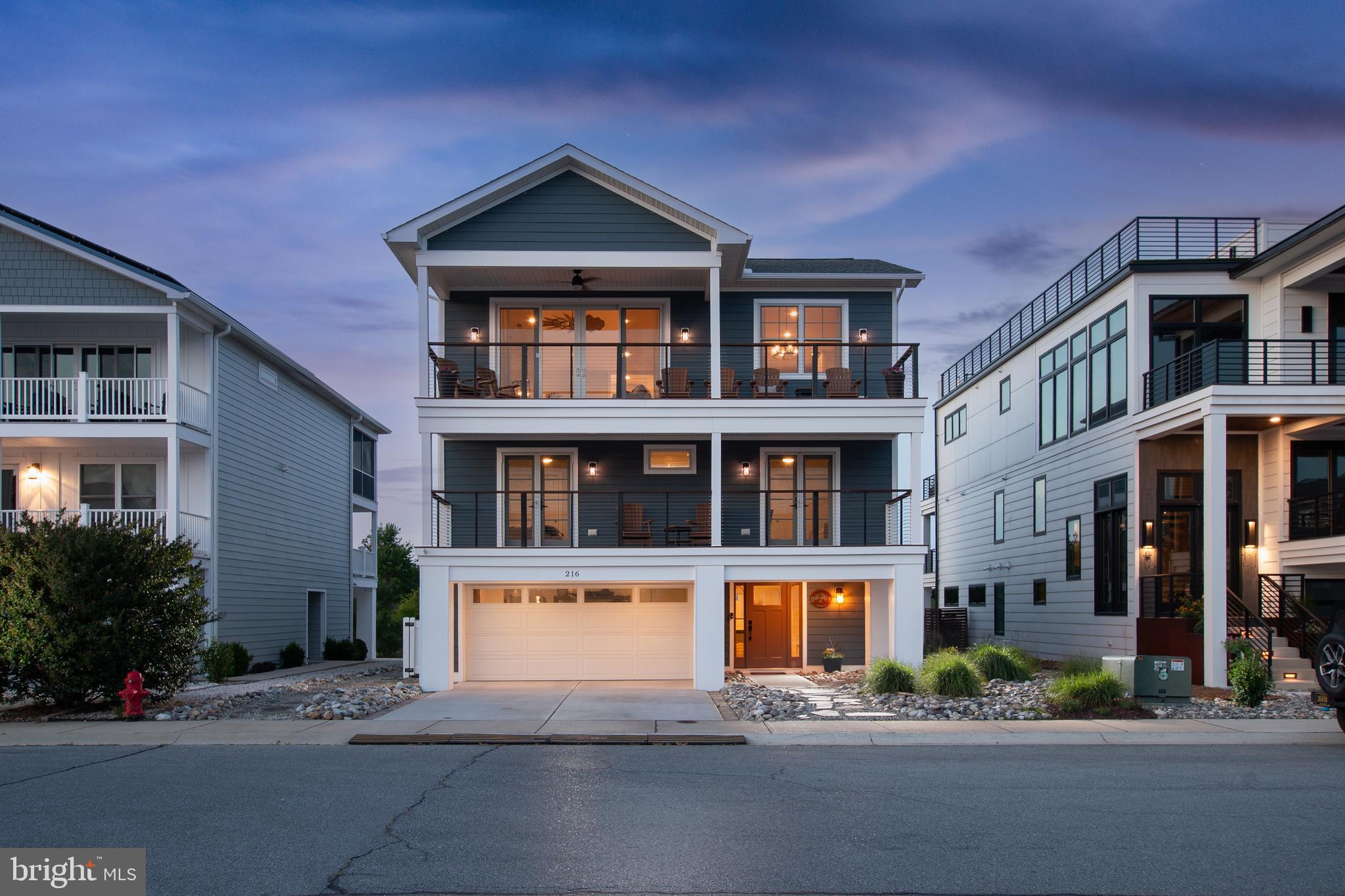 THE ULTIMATE COASTAL SANCTUARY! Welcome to a true masterpiece of modern seaside architecture in Anglers Nest! This meticulously designed 5-bedroom home offers an unparalleled lifestyle where panoramic vistas of the canal, salt marshes, and bay serve as your daily backdrop. The heart of the residence is the breathtaking top-floor great room, featuring soaring vaulted ceilings, luxury vinyl plank flooring, and a floor-to-ceiling shiplap fireplace. The gourmet chef’s kitchen is a showstopper, anchored by a massive quartz island and equipped with premium stainless steel appliances, and custom backsplash. Seamless indoor-outdoor living is achieved through expansive sliding glass doors that open to a large, covered balcony, perfect for watching the boats return to the harbor. The thoughtful layout provides ample space for family and guests, highlighted by multiple primary-style suites with spa-inspired bathrooms. Additional amenities include a mid-level office, wet bar with beverage fridge, multiple balconies, screen porch, patio, outdoor shower, hot tub, first floor flex room, and a soft, airy coastal palette throughout. Perfectly positioned just steps from the tranquil Bay Beach and seconds from the docks of the Lewes Rehoboth Canal, and historic downtown Lewes, this home represents a rare opportunity to own a front-row seat to the best of the Delaware coast.