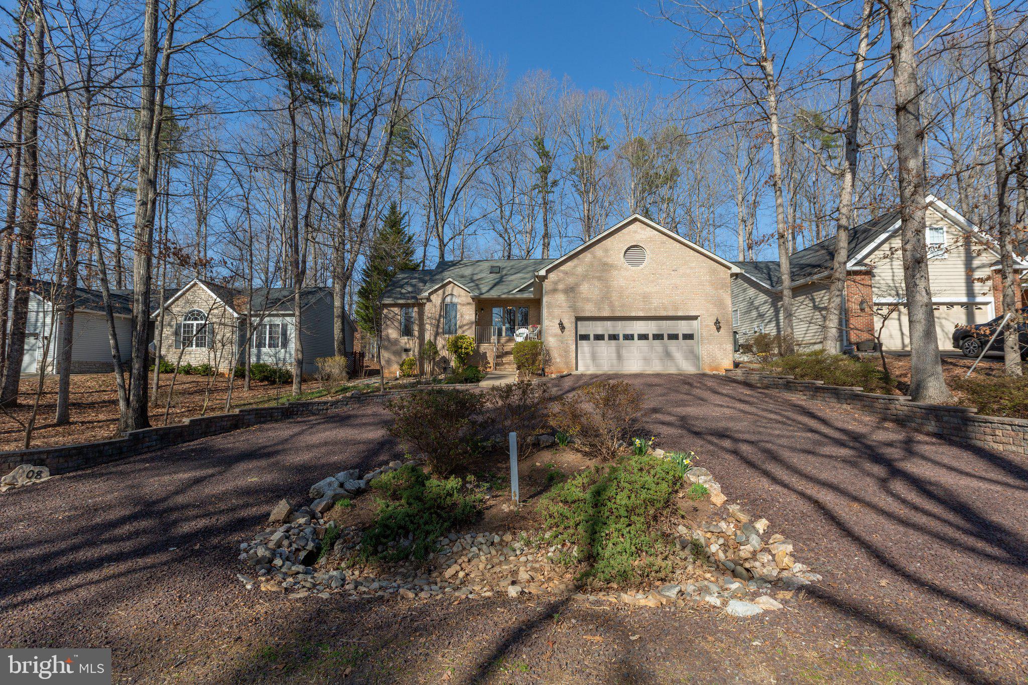 Welcome to this charming 3-bedroom, 2-bathroom  raised rambler located in the gated community of Lake of the Woods. This home offers the perfect blend of comfort and functionality, with a thoughtful layout that provides both privacy and open living spaces. 

Step onto the front porch and enjoy a beautiful *peak-a-boo* seasonal waterview, setting the perfect tone for relaxation. Inside, vaulted ceilings highlight the home's open feel, while the cozy gas fireplace adds warmth and ambiance to the living room. The adjacent dining area offers access to the back deck, perfect for seamless indoor-outdoor living and entertaining. The kitchen features gleaming granite countertops, stainless steel appliances, and space for a breakfast nook.
The house is a split bedroom design to allow for privacy and separation.  The primary bedroom is a true retreat, offering direct access to a relaxing screened porch where you can unwind in peace. The ensuite bath is luxurious with a step-in shower featuring multi-jet capabilities, creating a spa-like experience right at home.  On the opposite side of the living room, two well-sized secondary bedrooms share an updated hall bath.  
Outside, the freshly painted deck overlooks a stone patio and generous yard, providing an excellent space for entertaining or enjoying peaceful outdoor moments. 
The oversized 2-car garage is a standout feature, offering room for both parking and a hobby area, along with plenty of space for additional storage. 
The community of  Lake of the Woods offers numerous activities, from boating and waterskiing to horseback riding, golfing,  and community clubs.   Don’t miss out on this beautiful opportunity to make 108 Green Spring yours.