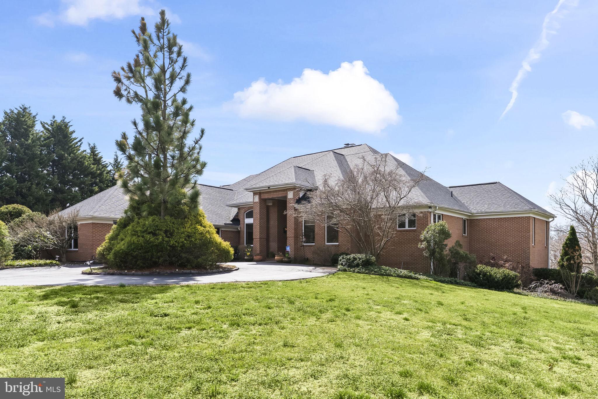 *Open House Saturday 5/16 from 10am-2pm*. Welcome to one of the most impressive homes in the prestigious Cannon Club Estates golf course community. This custom-built, all-brick residence offers ample square footage across three levels, including a finished basement, four bedrooms, three full bathrooms, and an exceptional four-space garage setup rarely found in the area. From the moment you enter, soaring vaulted ceilings and expansive windows create a bright, open atmosphere filled with natural light. The main living space centers around a striking three-sided wood-burning fireplace, providing warmth and character while creating the perfect setting for both everyday living and entertaining. A beautiful sunroom retreat "Gatsby Room" offers year-round enjoyment and features its own gas fireplace, ceiling fans, built-in sound system, and dimmable lighting while overlooking the private backyard and golf course. The kitchen includes newer stainless steel appliances and a functional layout designed for both convenience and hosting gatherings. The spacious primary suite offers a spa-like escape with a steam shower and soaking tub for ultimate relaxation. Downstairs, the finished basement provides additional flexible space perfect for a recreation area, home gym, or media room. Step outside to your own private outdoor retreat featuring a stunning three-tier patio and an in-ground heated plunge pool—ideal for entertaining or quiet evenings at home. Additional highlights include a new roof installed in 2020 with lightning rod protection and a hardwired security system compatible with any monitoring service. Homes with this combination of space, upgrades, and Cannon Club lifestyle rarely become available.  Golf or social country club membership is also optional.  Schedule to see today as this one will not last long!
