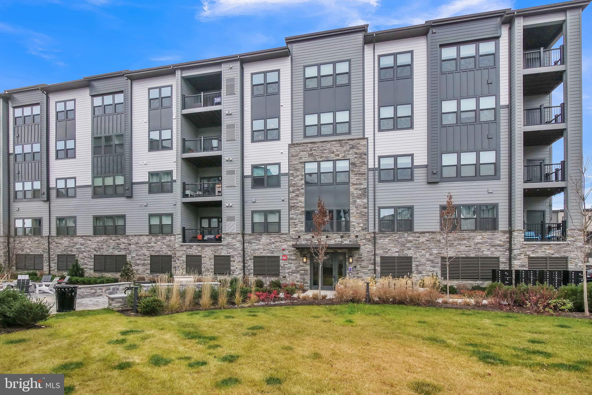 Welcome to this brand-new luxurious condominium in the vibrant MOSAIC AT WOODLAND PARK community.  A secured entrance sets the tone for the 1,162 sq ft of interior space, featuring 2 spacious bedrooms and 2 full baths. This residence seamlessly blends practicality with sophisticated chic style, showcasing a bright, open floor plan that extends to a covered balcony.  The modern kitchen is a focal point, boasting upgraded cabinets, a substantial center island, quartz counters, SS appliances, backsplash, and a deep apron sink. Additional touches include a pantry, pendant lights, recessed lights, and an eco programmable thermostat. Indulge in the magnificent owner's suite, complete with a large walk-in closet and a spa-inspired bathroom featuring dual vanities and a spacious shower area. The secondary bedroom is generously sized, and convenience is elevated with a laundry closet. Discover the convenience of an incredible prime location, offering an exceptional lifestyle with ample nearby shopping, dining, fitness options, studio-style gyms, movies, restaurants, meeting places, and parks. Commuting is a breeze with the Herndon Metro Silver Line just steps away (3/4 mile) and quick access to major routes, including 267, 28, and Fairfax County Parkway. Close proximity to Dulles International Airport underscores the excellence in style, function, and location.