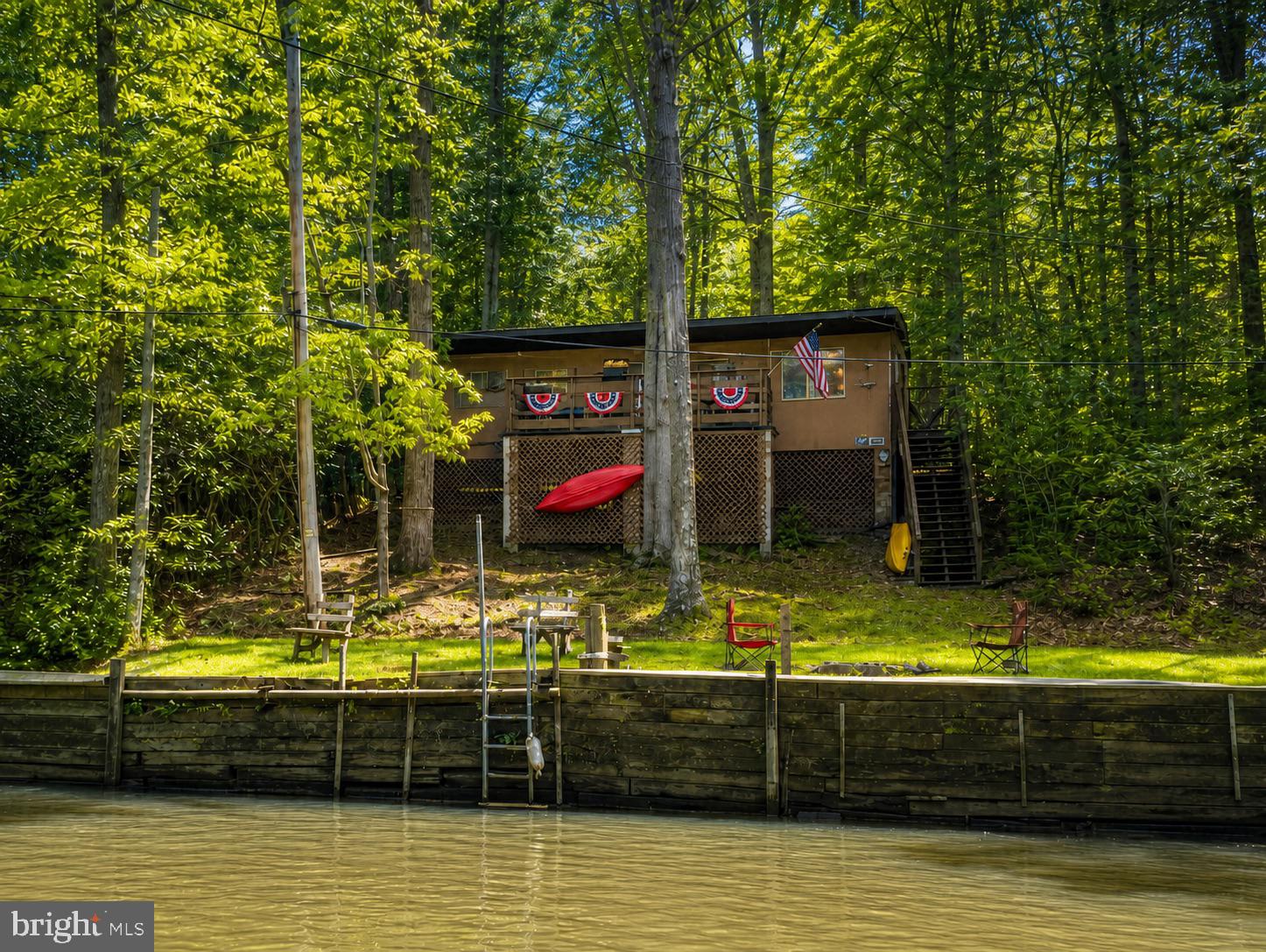 Amazing opportunity to own and enjoy a charming waterfront cabin in the Broad Creek cabin-owner community! Bring your boat, water skis, fishing rods, kayaks, and bikes for endless recreation on the water—or simply relax and enjoy the scenic wildlife. Offering approximately 50 feet of frontage, water views, and direct creek access, this well-maintained 1-bedroom, 1-bath cabin features a flexible bonus room, full kitchen, spacious great room with wood stove, and large waterfront deck. Updates include Lifeproof flooring, newer kitchen appliances, a 2026 water heater, and a roof approximately 9 years old. The bulkhead/dock area offers mooring potential, and the cabin is close to the Broad Creek public boat launch and Glen Cove Marina. Optional Broad Creek Association membership provides access to activities such as crab feasts and fishing tournaments and many more activityes. Additional features include split-system heating and cooling, shared well, holding-tank septic, shed, rear parking, and no-step rear entry. Cash only. Annual land lease through Constellation is approximately $2,980 and will be prorated at settlement. Recreational use only; no primary residence or short-term rentals. Buyer to verify all lease terms, restrictions, access, waterfront features, and property details.