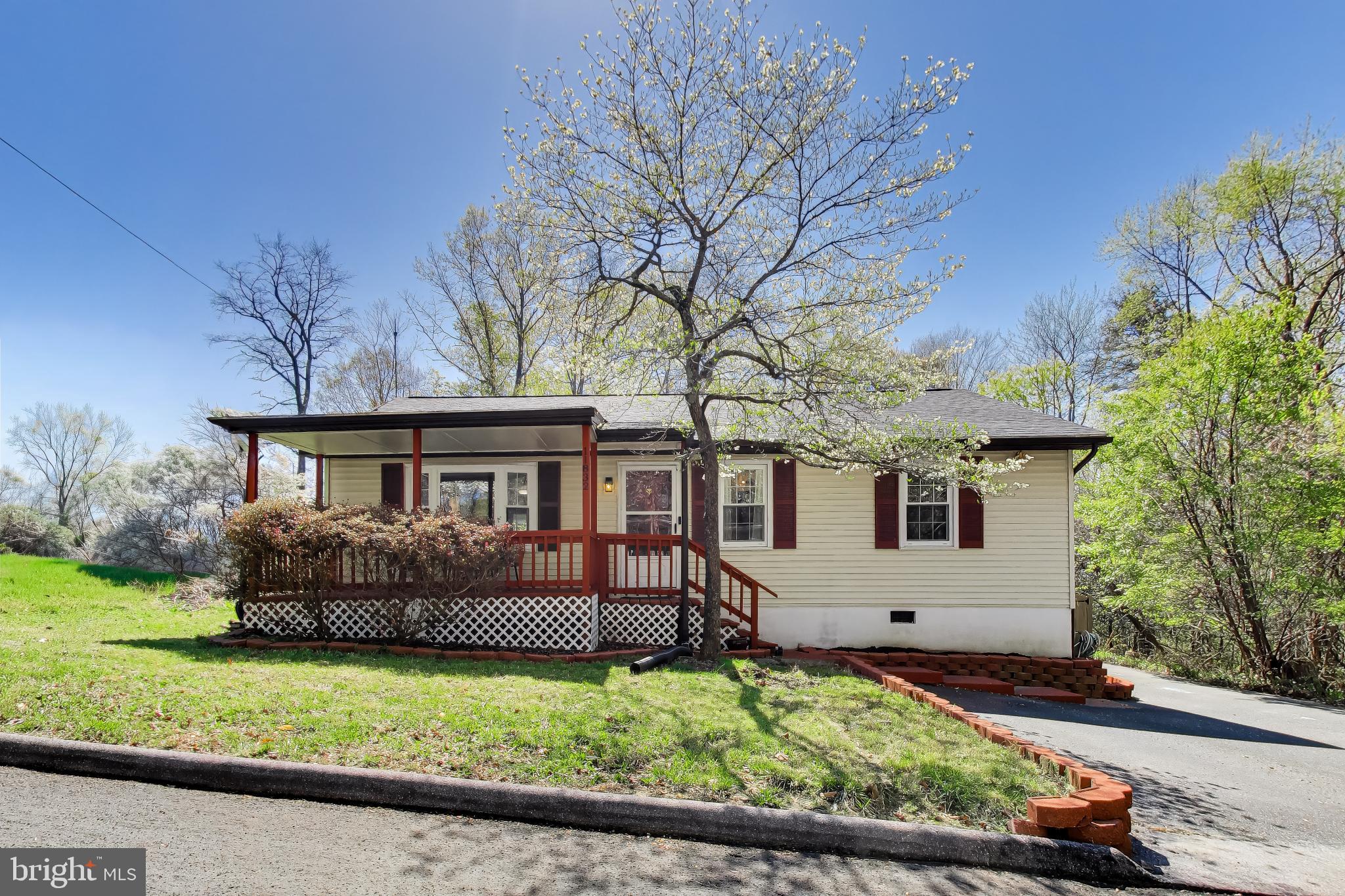 Beautifully updated rambler featuring 1,366 square feet of thoughtfully designed living space.  Recent upgrades include luxury vinyl plank flooring throughout and a renovated kitchen with quartz countertops, tile backsplash, stainless steel appliances, a 5-burner gas range, a built-in microwave, a center island, and a freestanding pantry cabinet.  Enjoy the light-filled sunroom off the kitchen with direct access to the deck and a fully fenced, private backyard backing to trees, complete with two storage sheds.  Originally a three-bedroom home, two bedrooms have been combined to create an oversized second bedroom, but can easily be converted back if desired. Additional highlights include a dedicated laundry room with built-in shelving and an updated full bathroom featuring ceramic tile flooring, a new tub, and tiled shower walls.  
The primary bedroom includes a supplemental baseboard heating unit for added comfort during colder months.  Relax on the large covered front porch, perfectly positioned on a quiet, no-through street ideal for peaceful living.  Major updates include a new roof and septic system (2023).  Community Amenities:  2 Private Beaches (Seahours & Driftwood), Lake Lariat, Campgrounds, Clubhouse & Trails
