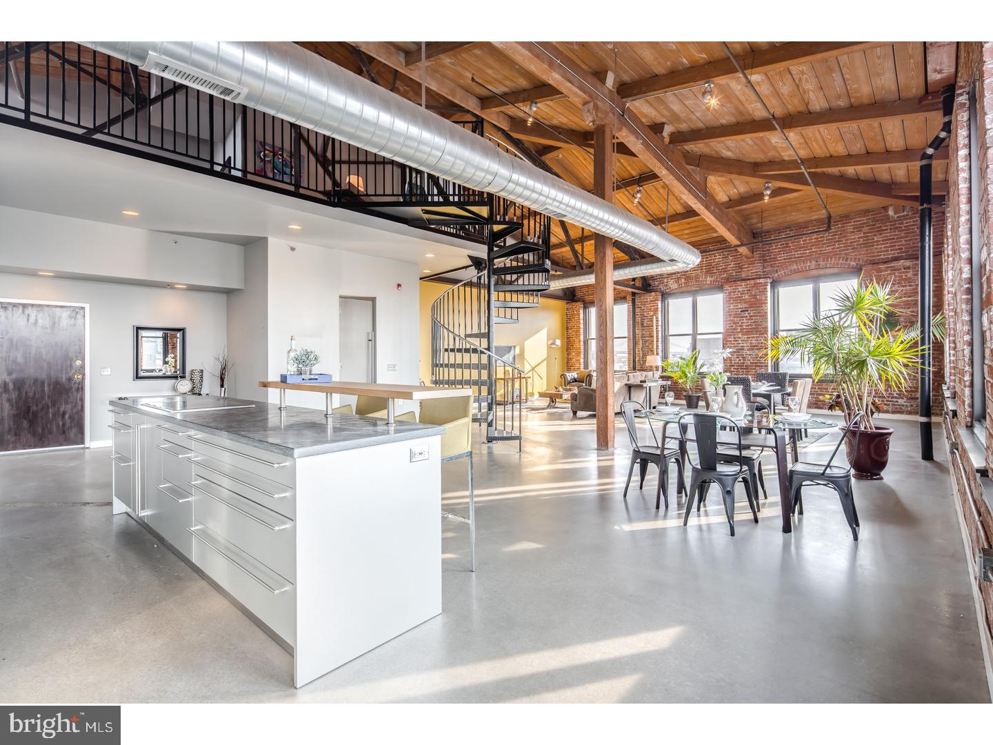 Welcome to this rarely offered, top corner penthouse loft in the historic Cigar Factory located in Philadelphia's beloved Northern Liberties. This gorgeous, Southwest top corner unit showcases exposed, heavy timber, steel and brick construction along with poured and polished concrete and bamboo flooring throughout. This loft is bathed with sunlight by one complete wall of windows which continues through the corner and offers spectacular and uncompromised views of the city. The open floor plan offers seamless and uncluttered living. The custom kitchen by Bulthaup features Miele dishwasher, ovens and espresso/coffee machine. Sub-Zero fridge and a Wolf flat top cook top layered on top of beautiful black /grey marble island. Beautiful bedroom with built in custom closets and master bath appointments by Phillip Starck/Duravit, Grohe fixtures, more Bulthaup cabinetry and gorgeous custom built wood vanities. This bi-level loft offers impeccable loft space that can be used for office space and/or another bedroom area. You will appreciate the vaulted ceilings equipped with skylights in this useful space overlooking this massive flat. This is a one of a kind display of craftsmanship that brings old and new together perfectly. The best of everything, not to mention 1 car-deeded garage parking. We welcome your visit today!