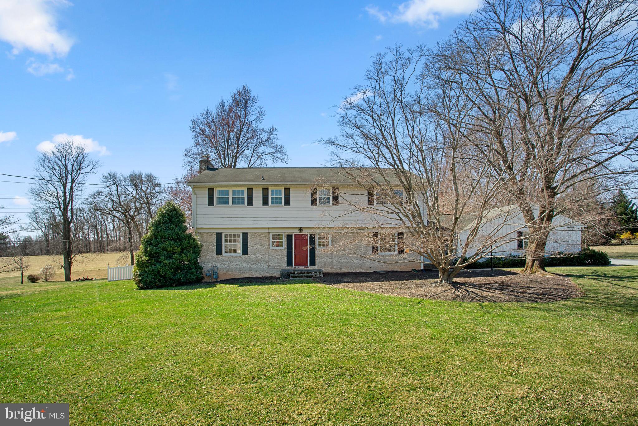 Charming Colonial residence spanning 4,008 square feet with 5 bedrooms, 3 full baths, and 1 half bath in picturesque Sunnybrook Farms, adjacent to Soldiers Delight Natural Environment Area for a serene setting. A beautifully landscaped front yard and expansive driveway set the stage for this inviting home, which blends farmhouse-inspired rustic charm with a traditional floor plan. 

Step into the foyer, where classic brick flooring and an elegant powder room welcome you. Hardwood floors flow throughout the main level, enhancing a spacious living room with a wood-burning fireplace, an exposed brick wall, and striking exposed solid wood beams, as well as a cozy study with built-ins. The fully remodeled gourmet eat-in kitchen features an island breakfast bar, granite countertops, exposed solid wood beams, ample white cabinetry with glass-front accents, open shelving,  a built-in wine rack, a charming tile backsplash with floral detailing, and an adjoining dining area with deck access for seamless indoor-outdoor entertaining. A spacious laundry corridor leads to a private in-law suite, complete with a separate exterior entrance, a great room, a full kitchen, a bedroom, and a full bathroom—providing a perfect retreat for guests or multi-generational living. 

Upstairs, four generously sized bedrooms with hardwood floors are complemented by two full bathrooms, including the primary suite with a walk-in closet and an en-suite bath. The lower level offers a bright recreation room with a wood-burning fireplace, a versatile bonus room with walk-up exterior access, and a utility room for extra storage.

Outside, enjoy the expansive open lot, a covered patio off the in-law suite, a spacious deck, and a fully fenced, flat backyard with 2 storage sheds and breathtaking countryside views.