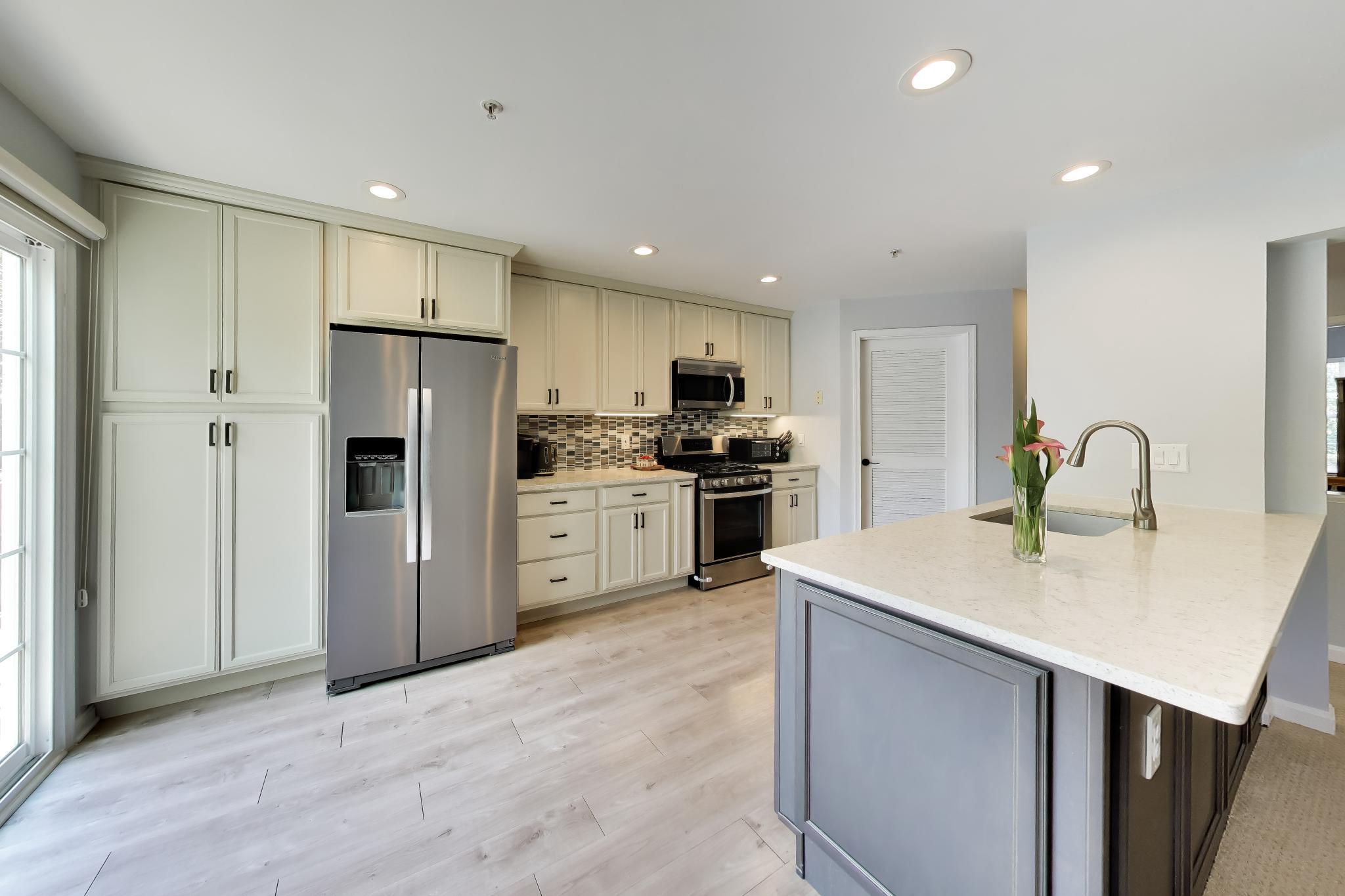 Welcome home to this well-loved, beautifully maintained property in the desirable Hunters Woods community! This East-facing, West-backing, three and a half-level contemporary townhome condo is filled with light throughout the day with a layout so open and unique you truly must see it to appreciate it because the photos can't do it justice. You’ll be welcomed into the home with a foyer and the door to your 1 car garage- a rare find in homes like this! In addition to your garage, you have your own driveway and permit for additional private parking lot spot. Head upstairs where you’ll see square-footage doesn't feel wasted especially with stunning vaulted ceilings in nearly every room in this 3 bedroom, 2.5 bathroom abode with two balconies which have recently been updated by the HOA) that further add to the living space. Enjoy a fully updated, custom kitchen with stainless steel appliances, granite counters, and sleek pantry and lower cabinets all with pull out shelving. The main level offers an open concept living style with a gas fireplace which adds to the cozy ambiance. On the upper level, you’ll find a convenient laundry closet, full hall bath, spacious secondary bedroom and a generous primary suite complete with customized walk-in-closet (Closet America with lifetime warranty) and an updated private full bathroom. With updates done to all bathrooms and custom built-ins to maximize storage space in every closet, there’s nothing left for you to do but move in! 
Just SOME highlights of this location: steps from the Hunters Woods Plaza for shopping and dining necessities, right next to a community center boasting an indoor pool and countless offerings, less than 2 miles to the popular Reston Town Center, less than 8 miles to Dulles Airport, centrally located to several metro stations and bus stops, and direct access to multiple walking and bike trails. Don’t miss your chance to own this move-in ready and rarely available home and be a part of all that Reston has to offer!