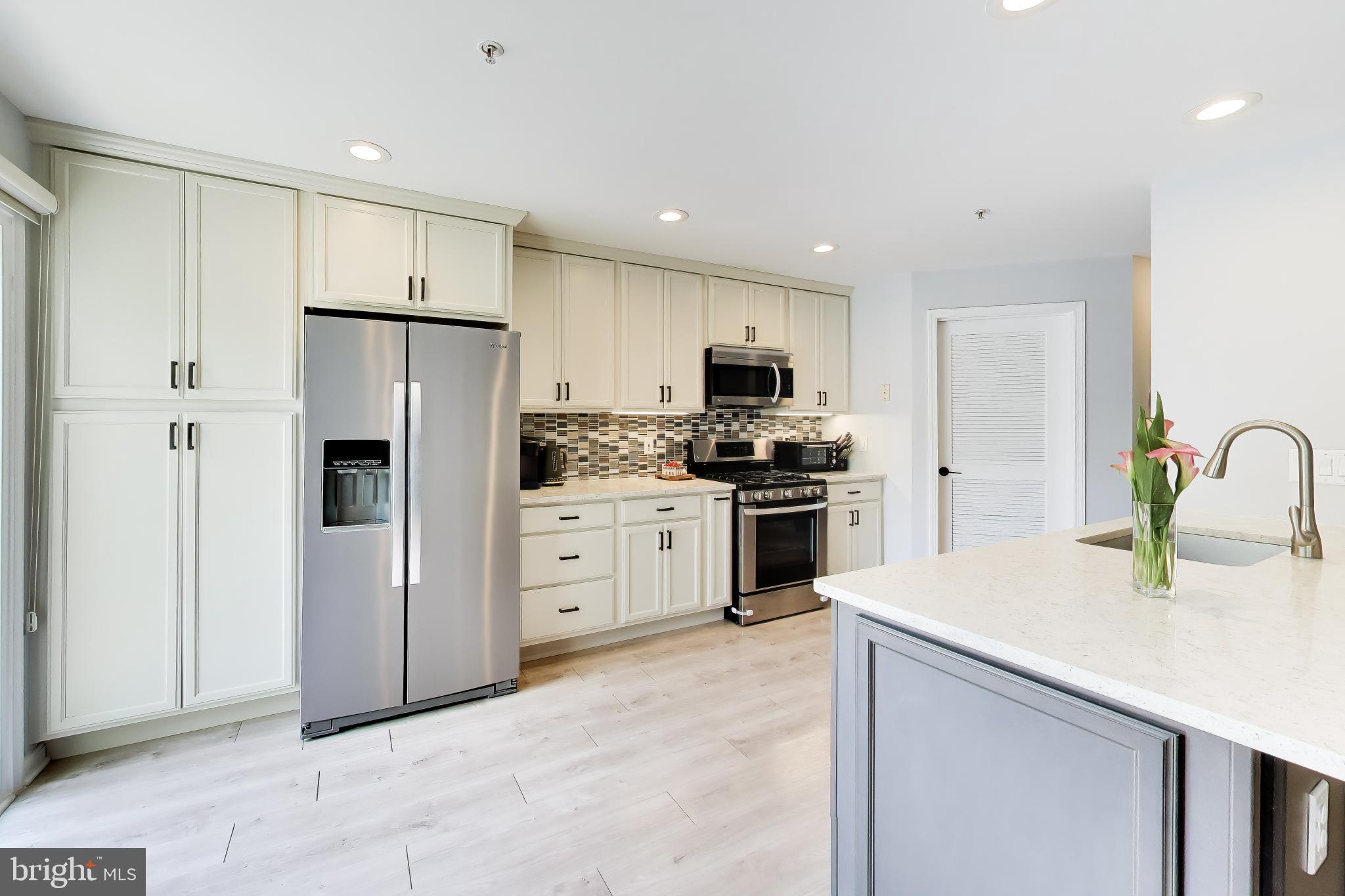 Welcome home to this well-loved, beautifully maintained property in the desirable Hunters Woods community! This East-facing, West-backing, three and a half-level contemporary townhome condo is filled with light throughout the day with a layout so open and unique you truly must see it to appreciate it because the photos can't do it justice. You’ll be welcomed into the home with a foyer and the door to your 1 car garage- a rare find in homes like this! In addition to your garage, you have your own driveway and permit for additional private parking lot spot. Head upstairs where you’ll see square-footage doesn't feel wasted especially with stunning vaulted ceilings in nearly every room in this 3 bedroom, 2.5 bathroom abode with two balconies which have recently been updated by the HOA) that further add to the living space. Enjoy a fully updated, custom kitchen with stainless steel appliances, granite counters, and sleek pantry and lower cabinets all with pull out shelving. The main level offers an open concept living style with a gas fireplace which adds to the cozy ambiance. On the upper level, you’ll find a convenient laundry closet, full hall bath, spacious secondary bedroom and a generous primary suite complete with customized walk-in-closet (Closet America with lifetime warranty) and an updated private full bathroom. With updates done to all bathrooms and custom built-ins to maximize storage space in every closet, there’s nothing left for you to do but move in! 
Just SOME highlights of this location: steps from the Hunters Woods Plaza for shopping and dining necessities, right next to a community center boasting an indoor pool and countless offerings, less than 2 miles to the popular Reston Town Center, less than 8 miles to Dulles Airport, centrally located to several metro stations and bus stops, and direct access to multiple walking and bike trails. Don’t miss your chance to own this move-in ready and rarely available home and be a part of all that Reston has to offer!