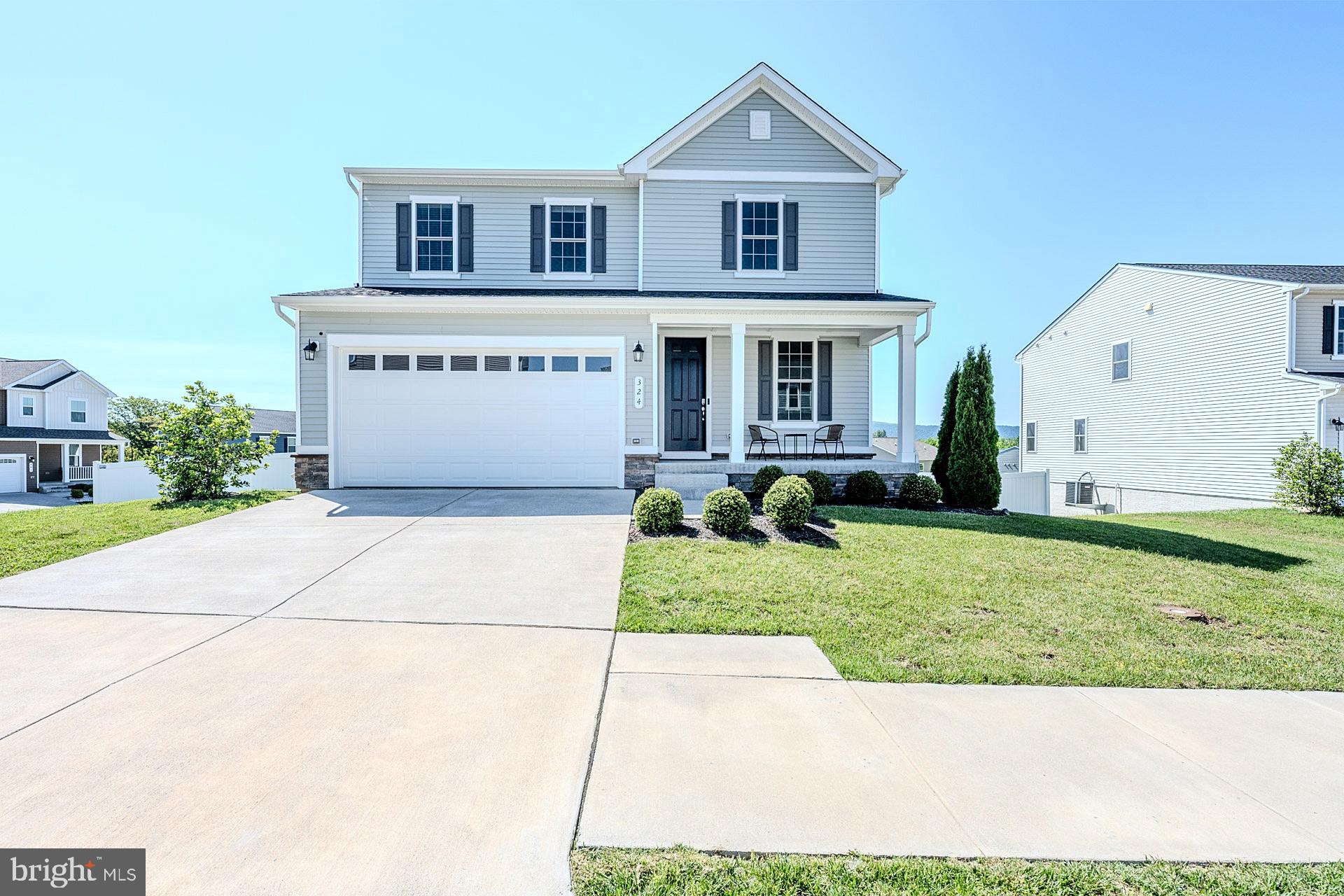 Welcome to this beautifully maintained 3-bedroom, 2.5-bath single-family home in one of Strasburg’s newer and sought-after subdivisions. Set on a desirable corner lot with one of the largest yards in the neighborhood, this home offers 2,235 square feet of thoughtfully designed living space, a 2-car garage, modern finishes, and peaceful mountain views. ****** A charming front porch welcomes you as you step into the main level featuring an open-concept layout with warm luxury vinyl plank flooring that flows throughout the living room, kitchen, dining, and family room areas. The kitchen offers an abundance of 42” white shaker style cabinetry, gleaming granite countertops, a walk-in pantry, and stainless-steel appliances. A large center island with chic pendant lighting provides bar seating and easy flow into the dining area and spacious family room, where a sleek modern electric fireplace with blower creates a warm and inviting focal point. Large triple sliding doors open to the deck, where you can relax and take in the beautiful mountain views and quiet neighborhood setting. A powder room and mudroom area with direct garage access rounds out the main level. ****** Upstairs, you’ll find a versatile loft area that is perfect for a sitting/study/play area. The spacious primary suite boasts walls of windows, plush carpet, a lighted ceiling fan, and huge walk-in closet. The luxurious ensuite bath features a granite topped dual sink vanity, an additional vanity area, water closet, and an oversized glass enclosed shower. Two additional bedrooms, each with lighted ceiling fans, share access to the hall bath with a granite topped dual sink vanity and tub/shower combo. A large laundry room with utility sink adds convenience.  The expansive unfinished walk-out lower level with full bath rough-in provides loads of storage space and excellent potential for room to expand with your own personal design! ****** Outdoor living is a true highlight, with an extended PVC/vinyl fenced yard, enlarging the outdoor space, and newly planted Leland cypress and additional trees designed to enhance future privacy. Additional features include Bluetooth surround sound, a Wi-Fi extender, modern finishes, and convenient access to shopping, major routes, and I-66 for commuters. This home combines comfort, functionality, and scenic surroundings in a peaceful Strasburg setting. Qualified buyers may be eligible for Zero Mortgage Closing Costs, potentially saving thousands at closing. Contact listing agent for details!