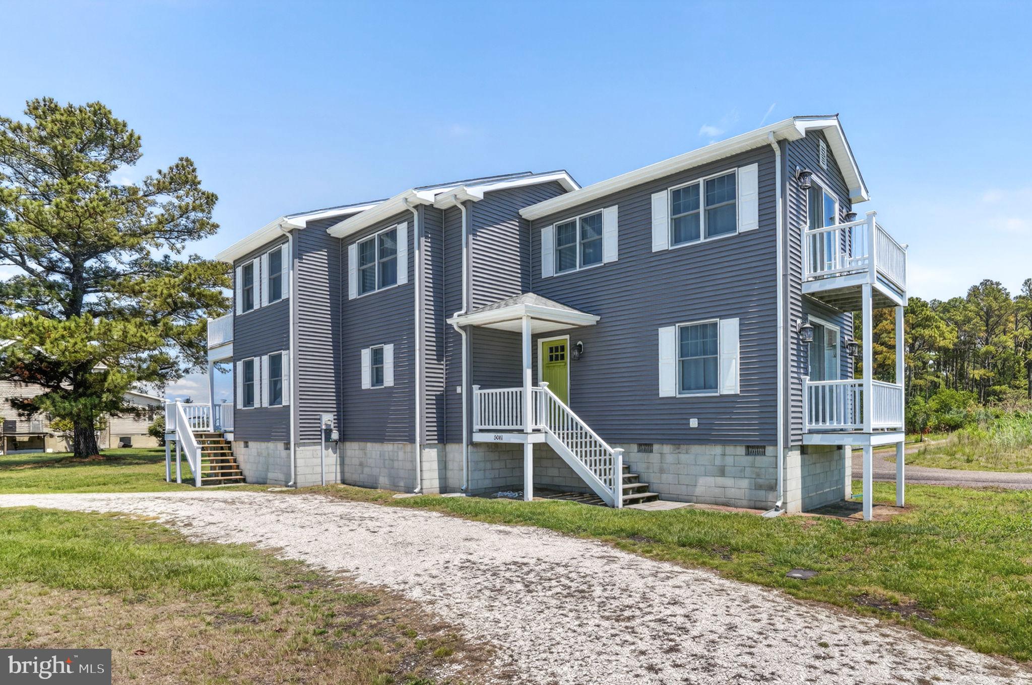 You will LOVE the views! Enjoy beautiful views of Chincoteague Bay from this well-maintained coastal home in the desirable Bay Colony community. Situated on a spacious lot, this elevated 3-bedroom, 2-bath home offers the perfect blend of island charm, comfortable living, and outdoor enjoyment.

Designed to take advantage of the surrounding scenery, the home features multiple covered porches, balconies, a screened porch, and expansive wraparound decking, providing numerous places to relax, entertain, and enjoy the coastal breezes. Bay views can be enjoyed from multiple areas of the home, creating a true island retreat.

Inside, the upper level serves as the heart of the home, featuring an open-concept kitchen, dining area, and family room filled with natural light. The kitchen offers stainless steel appliances, abundant cabinetry, breakfast bar seating, and seamless flow into the living and dining spaces, making it ideal for everyday living and entertaining. Sliding doors lead to the screened porch, creating an inviting extension of the living area.

The thoughtfully designed floor plan includes a spacious first-floor primary bedroom with direct access to the covered porch, an additional first-floor guest bedroom and full bath, plus a private upstairs bedroom and full bath with balcony access. A dedicated laundry area adds convenience, while tile flooring throughout the main living areas enhances the home's easy-care coastal appeal.

Additional features include vinyl siding, public water, private septic, detached storage shed, enclosed under-house storage, and an outdoor shower—perfect for rinsing off after a day at the beach or on the water. Being sold furnished with appliances included, this move-in-ready property offers a turnkey opportunity as a primary residence, vacation getaway, or investment property.

Conveniently located near Chincoteague's shops, restaurants, marinas, wildlife refuge, and Assateague Beach, this is your opportunity to experience the very best of island living with beautiful bay views and easy access to everything the island has to offer.