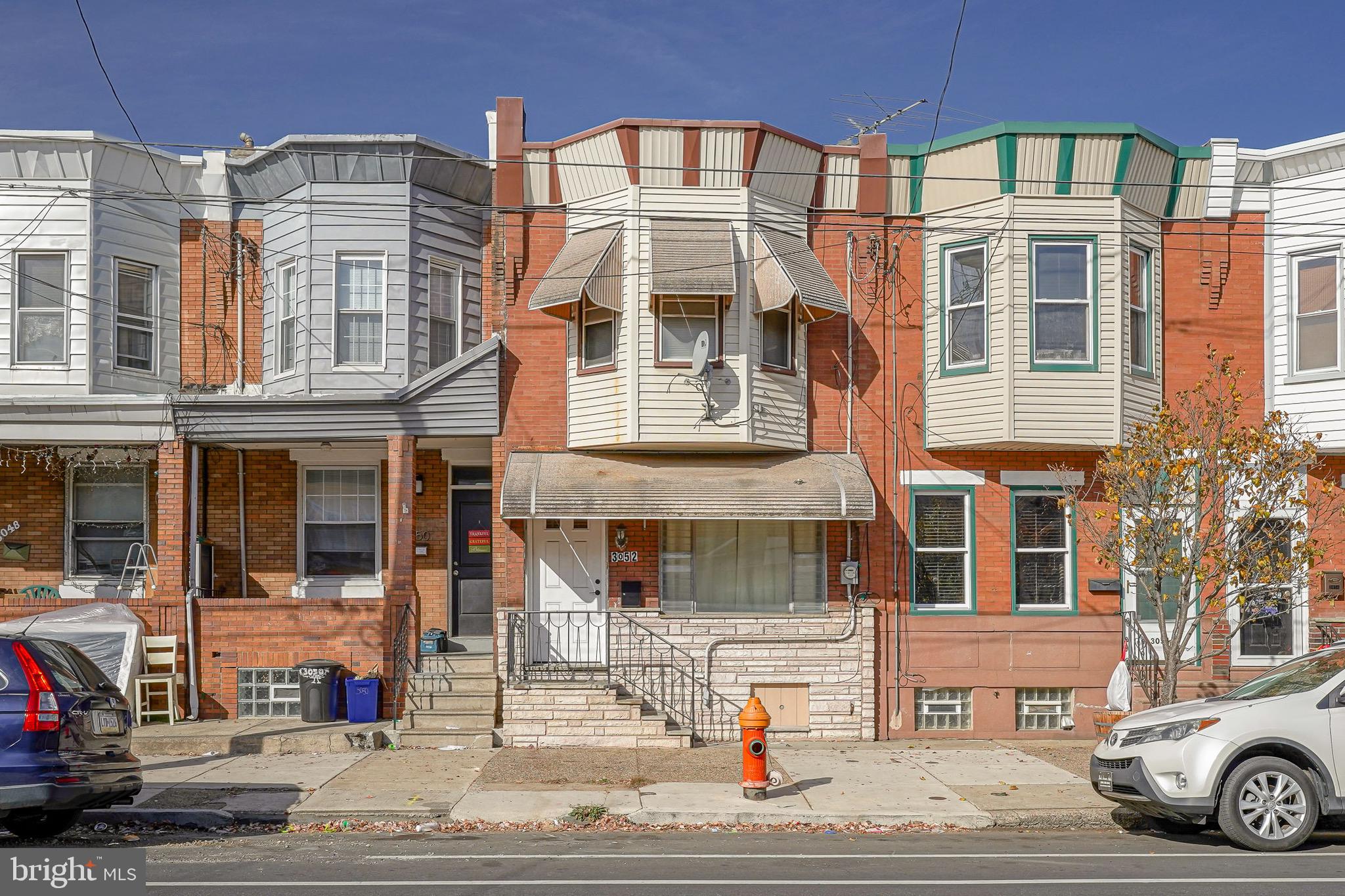 Beautifully updated 3-bedroom, 1.5-bathroom brick and stone front straight thru nestled in the heart of the vibrant Port Richmond community. Enter to find newly installed hard wood floor and fresh paint throughout.  That main level features a cozy fireplace anchoring the living area, perfect for chilly evenings that leads to a large dining area with tiled floors and nice chandelier. The kitchen is enhanced with ceramic tiled floors, and abundance of new cabinets with granite counters and subway tiled backsplash, providing both beauty and practicality for your cooking adventures and exits to the private rear yard that is great for entertaining. Upstairs you will find 3 well-appointed bedrooms that all have ceiling fans and plenty of closet space and a full bath with beautifully tiled surrounds to provide comfortable retreats for family members or guests.  Not to be outdone, the basement is a true gem! Fully finished and featuring a handy half bath, it’s your go-to for entertainment, storage, or just kicking back for some recreational downtime and also hosts the separate laundry area. And for those who love a bit of outdoor living, the large, fenced backyard offers ample space for gardening, play, or simply soaking up the sunshine.  Location? Nestled in a friendly community, the home is just a stone's throw from local conveniences like the ShopRite on Aramingo Avenue for your grocery needs, and General Pulaski Park for some greenery and outdoor fun. If you're a commuter or just love to explore, the proximity to Bridesburg train station and I-95 just right around the bend!