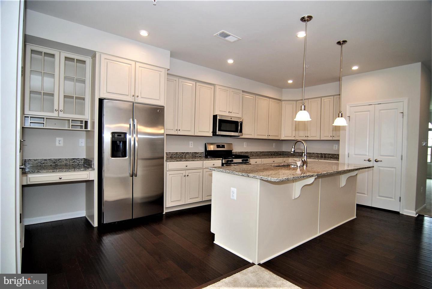 Beautiful and spacious condo totaling 2777 sq foot of great living space.  Open living concept with the Living Room at the front of the unit with lots of natural light.  The spacious kitchen features SS appliances, upgraded cabinets and granite countertops and a large island.  The Family room is accented by a corner gas fireplace. Enjoy the evenings on the covered balcony accessed from the kitchen.  The bedroom level has two spacious secondary bedrooms with a hall bathroom and a second floor laundry room with full size washer and dryer. Owner's suite includes a sitting area, tray ceiling while the bathroom boasts of dual vanities, soaking tub and separate shower.   Lowest level offers a one car garage.  Perfectly located to all major commuter routes, minutes from downtown Frederick and loads of shopping nearby.