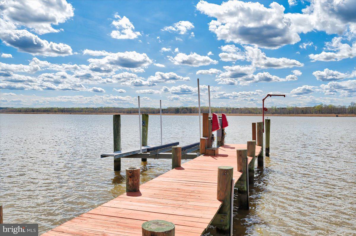 Don’t miss the beautiful sunsets over the Paxtuent. Just 45 minutes from the district, this waterfront retreat is a one of a kind.The main house has over 5,000 SF of living space and boasts an open, main-level, floor plan with a tremendous kitchen, incredibly large island and pantry with tons of space.  The wall of glass provides unbeatable views of the Patuxent and protected nature preserve that sits across the river.  The views continue to the primary suite with a wall of windows and fireplace. The primary bathroom has his and her toilet rooms. Plus you will find a laundry room on this level. Two more bedrooms, two baths and an office round out the main level living space. The walkout basement has tons of space, a second kitchen, 2 living spaces with fireplaces, full bath, bedroom and craft room. A wall of sliders open to the pool deck that over looks the water. The pier is very unique with it’s roof top deck has views for miles. There are also 2 boat lifts. 
The property also has a 1200 square foot carriage house. This two bedroom, 2 full bath home has full kitchen open living space with 10 foot ceilings and views of the river.  It sits over a large garage that has 9 foot doors for all your toys.
From the moment you drive on the property you will see the pride in ownership. You don’t want to miss this exceptional waterfront property.