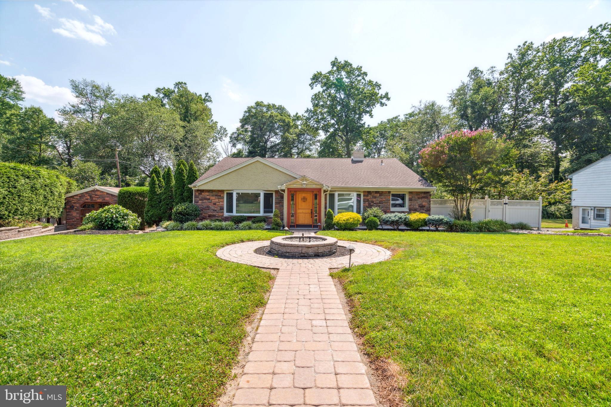 JUST REDUCED 50K, this refined contemporary home with exquisite character and charm is located right in Jenkintown’s most coveted neighborhoods. Enter to experience the elegant living room and formal dining room with 9-foot-high ceilings, romantic archways, vast bay windows with custom curtains, and crown molding and recessed lighting throughout the entire home. Complete with a full bath with a quaint brick wall detail and door leading outside to the back garden. Upstairs, the beautifully finished hardwood floors continue to grace the home as the 2 master suites and spacious bedroom with prominent closet space and 3 updated full bathrooms are explored. The primary master suite has a spectacular spa style full bath with 12 jets bathtub, double headed shower and built in foot spa for full relaxation. The serene ambience continues to the 1st floor as the Florida style bonus room overlooks the magnificent waterfall of the outdoor koi pond. While the gourmet custom kitchen is an absolute chef’s dream with gleaming granite surfaces, custom wooden cabinetry with pantry,  custom backsplash tile, and stainless appliances. This floor is accompanied by a chic bar with white quartz countertop, 2 wine refrigerators, with a wooden wine rack, a cozy sitting area with a marble fireplace, laundry room with white quartz counter and washer and dryer, and an updated full bathroom to complete the amenities. The back of the home has a grand outdoor oasis decorated with stone pavers. Step outside to the back patio to a unique stone fireplace with an outdoor kitchen including a barbeque grill, sink, and mini fridge. Entertain while enjoying the beautiful garden space that wraps around the entire backyard and have guests park in the extensive driveway or in one of the 4 detached garages.  Additional features of the home include an elevator, HVAC system, tankless water heater, backup generator, rear steel fence with outdoor lighting, timed outdoor lighting and sprinkler system. You will fall in love with the extraordinary quality of this enchanting home.