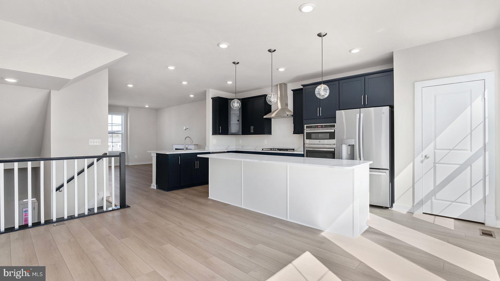 Discover Mary’s Landing, a new construction townhome community in the heart of Fredericksburg. These modern three-level homes with two-car garages combine style, space, and low-maintenance living just minutes from downtown shops, dining, and the Rappahannock River. Enjoy historic charm, outdoor recreation, and convenient access to I-95, Route 1, and the VRE—making commuting simple and weekends full of possibilities.
Step inside the Upton on the lower level, where a welcoming fourth bedroom greets you from either the front entry or the rear two-car garage. On the main level, the Upton shines with an open-concept design. The spacious family room provides plenty of room for relaxation and entertaining, with a cozy fireplace as a focal point. The adjacent kitchen is the true centerpiece, featuring a large island, ample counter space, and a dedicated dining space. Extend your living space outdoors with the optional sliding glass door and rear deck—perfect for morning coffee or evening gatherings. Upstairs, the Upton continues to impress with three bedrooms, two full bathrooms, and convenient bedroom-level laundry. Two secondary bedrooms share a hall bath, while the private primary suite offers a walk-in closet and a luxurious bathroom complete with dual sinks and a walk-in shower. The Upton is more than a townhome—it’s a home designed for modern living, offering the flexibility to adapt to your lifestyle today and for years to come.