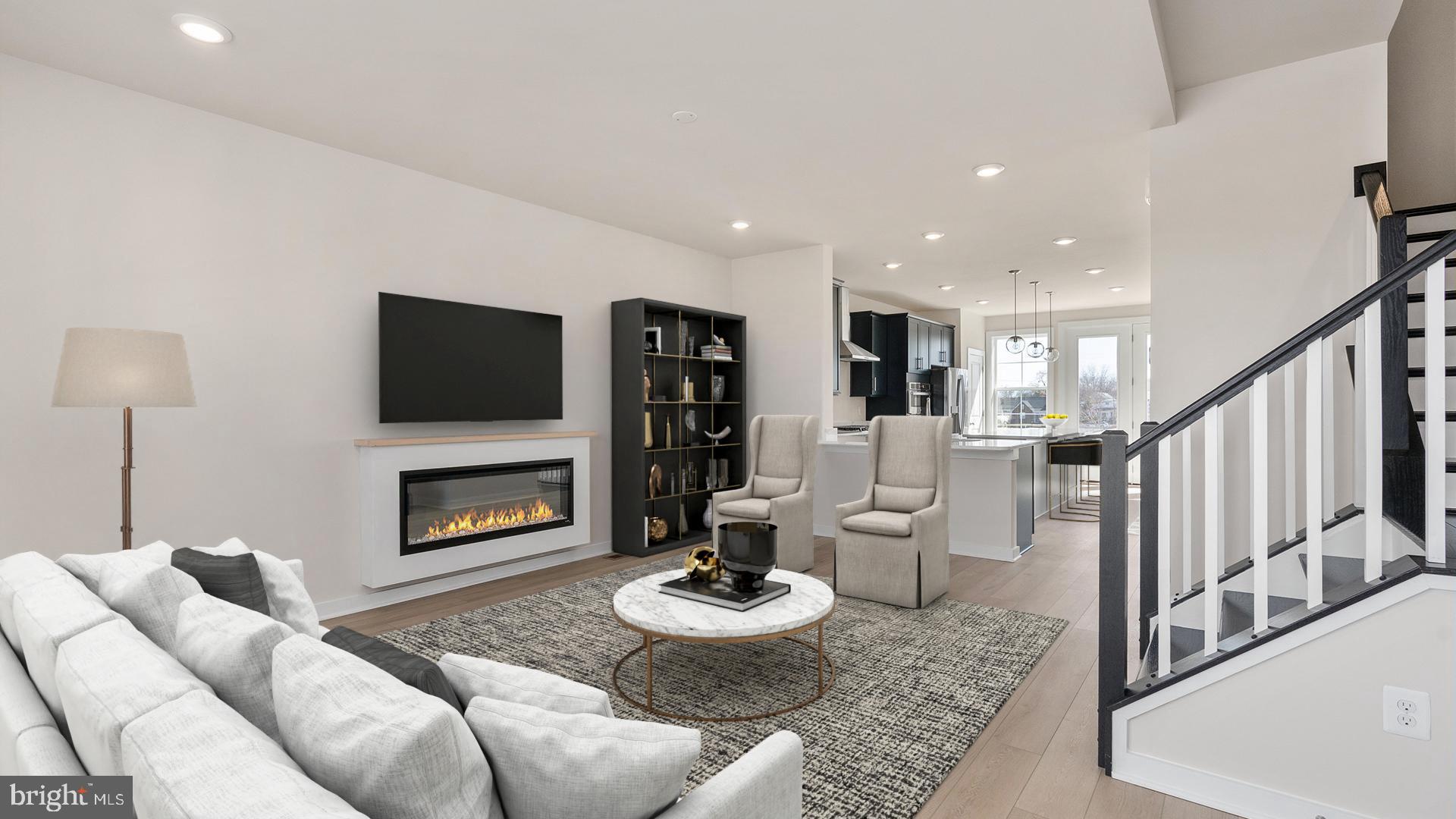 Discover Mary’s Landing, a new construction townhome community in the heart of Fredericksburg. These modern three-level homes with two-car garages combine style, space, and low-maintenance living just minutes from downtown shops, dining, and the Rappahannock River. Enjoy historic charm, outdoor recreation, and convenient access to I-95, Route 1, and the VRE—making commuting simple and weekends full of possibilities.
Step inside the Upton on the lower level, where a welcoming fourth bedroom greets you from either the front entry or the rear two-car garage. On the main level, the Upton shines with an open-concept design. The spacious family room provides plenty of room for relaxation and entertaining, with a cozy fireplace as a focal point. The adjacent kitchen is the true centerpiece, featuring a large island, ample counter space, and a dedicated dining space. Extend your living space outdoors with the optional sliding glass door and rear deck—perfect for morning coffee or evening gatherings. Upstairs, the Upton continues to impress with three bedrooms, two full bathrooms, and convenient bedroom-level laundry. Two secondary bedrooms share a hall bath, while the private primary suite offers a walk-in closet and a luxurious bathroom complete with dual sinks and a walk-in shower. The Upton is more than a townhome—it’s a home designed for modern living, offering the flexibility to adapt to your lifestyle today and for years to come.
